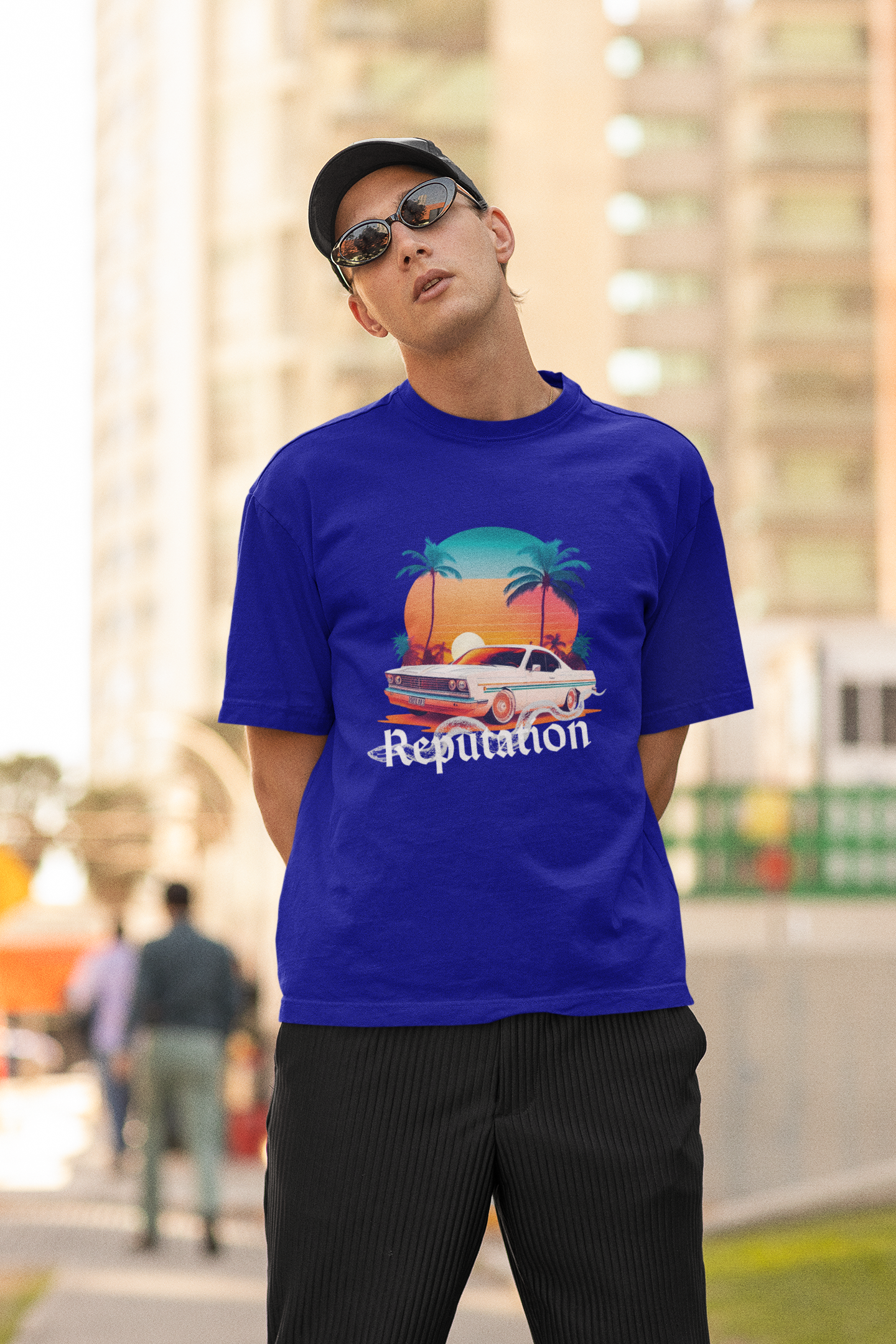 Second image of man wearing blue Oversize t-shirt featuring Reputation Taylor's Version design inspired by Taylor Swift's Reputation era