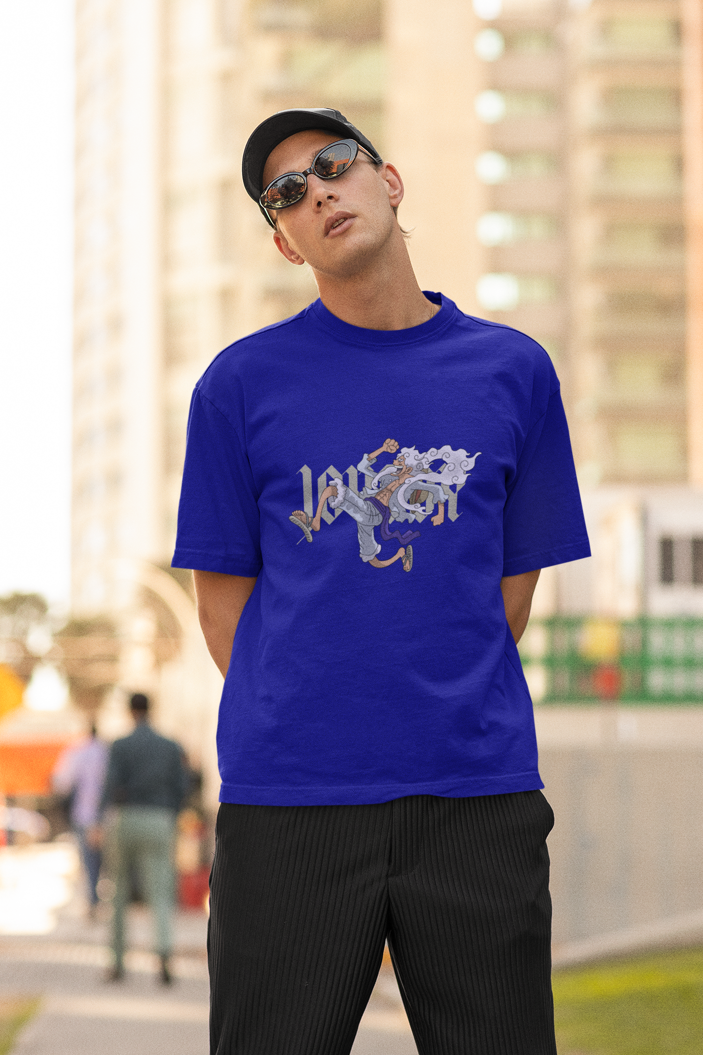 2nd front view of a male model wearing a royal blue oversized t-shirt featuring Luffy in his Gear 5 form from the One Piece anime.
