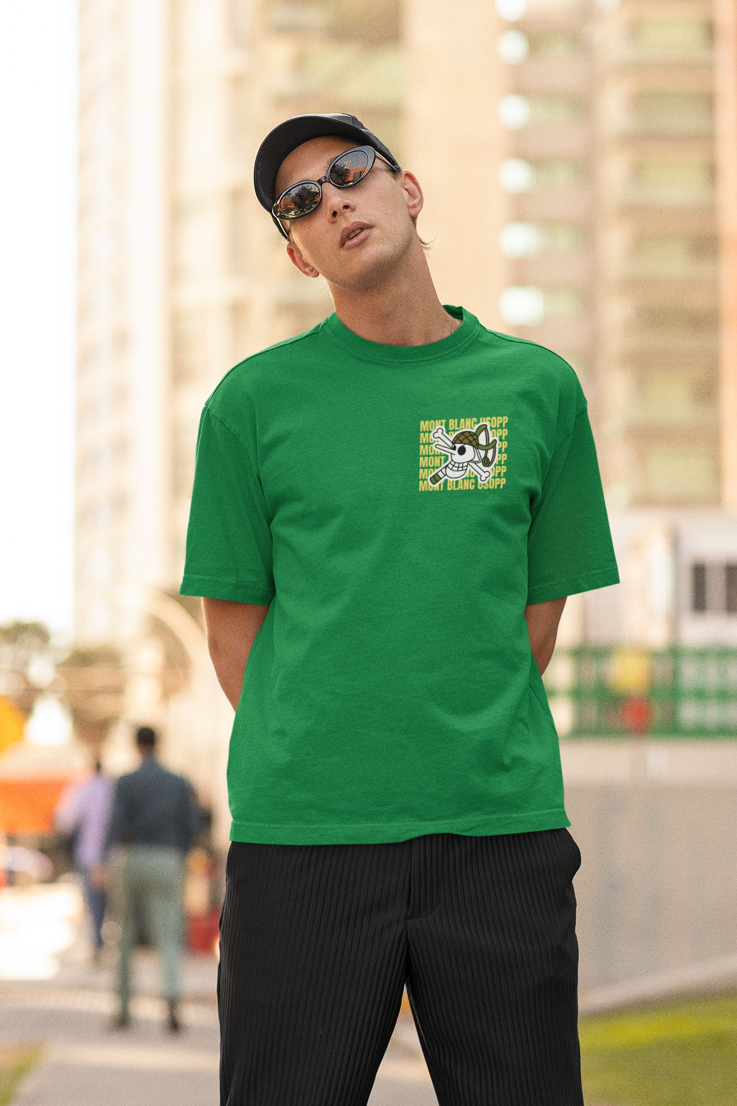 2nd front view of a male model wearing a forest green oversized t-shirt featuring Usopp from the One Piece anime.