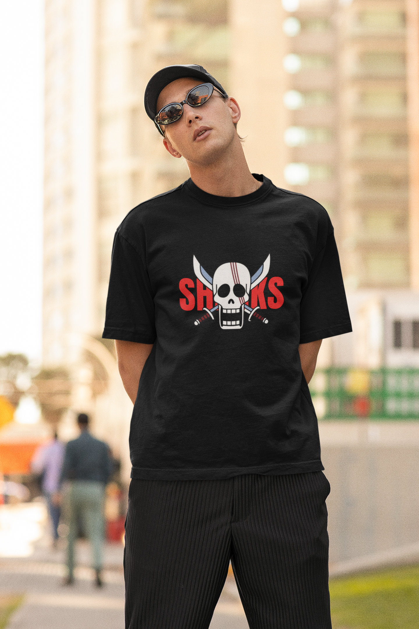 2nd front view of a male model wearing a black oversized t-shirt featuring Red-Haired Shanks from the One Piece anime.