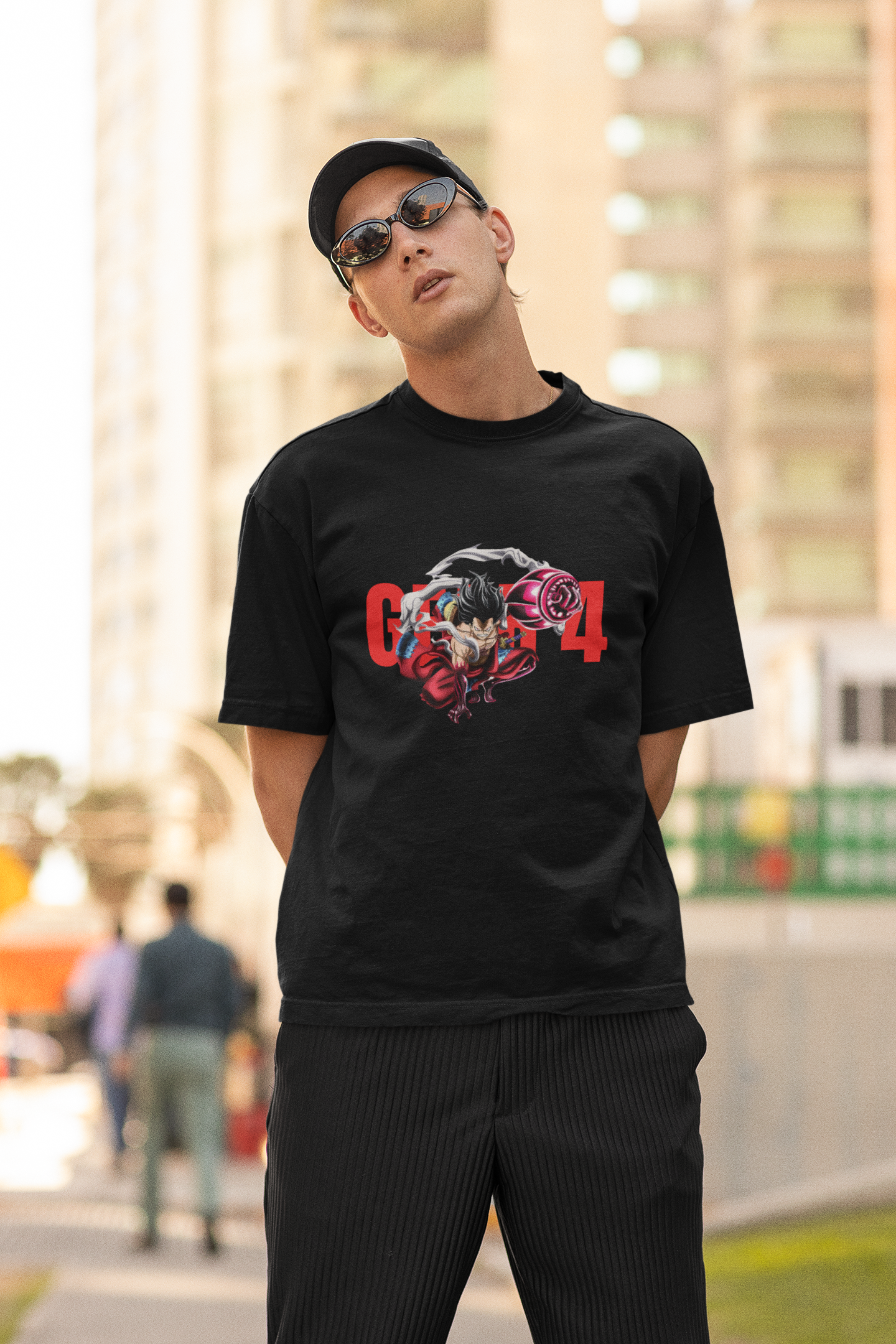 2nd front view of a male model wearing a black oversized t-shirt featuring Luffy in his Gear 4 Bounceman form from the One Piece anime.