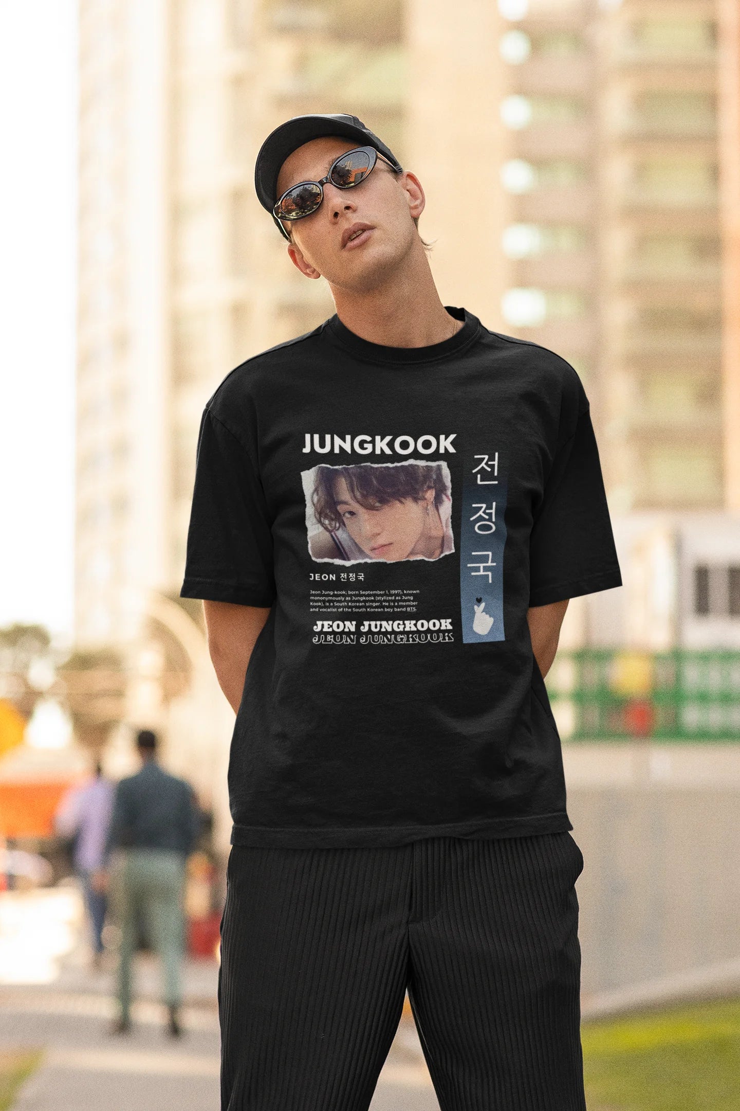Second  front view of a male model wearing a black oversized t-shirt featuring a vibrant design inspired by BTS member Jungkook. Ideal for fans of BTS and K-Pop music in general.