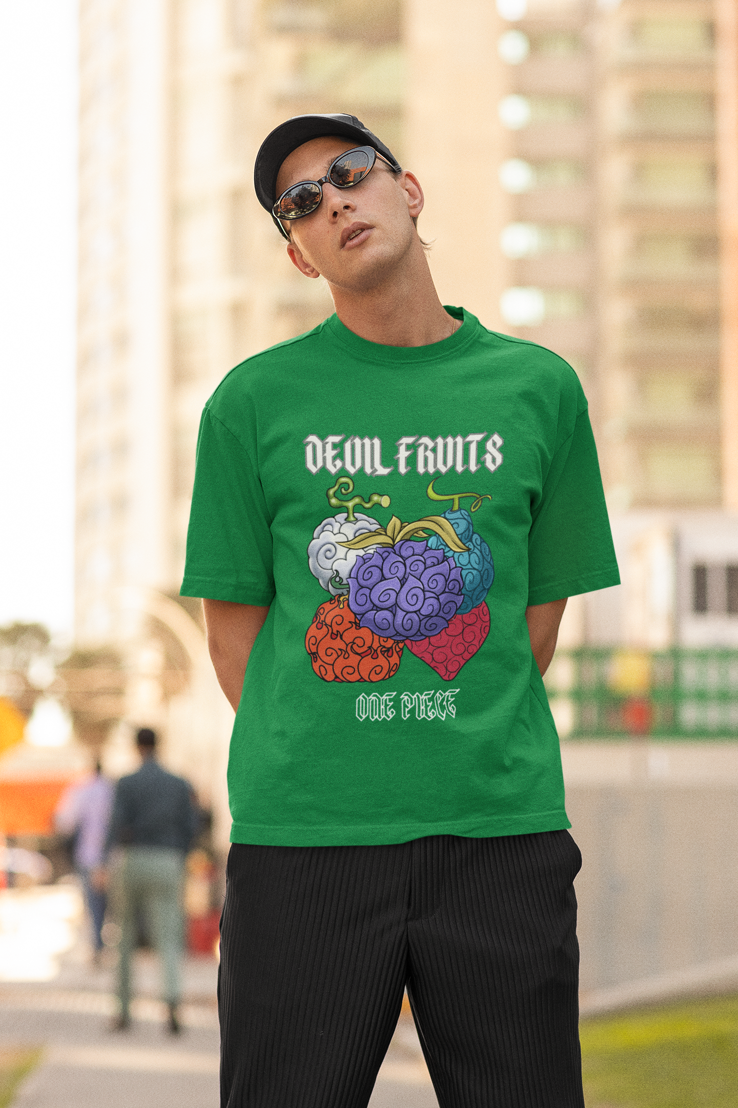 First front view of a male model wearing a forest green oversized t-shirt featuring a design of a Devil Fruit from the One Piece anime.