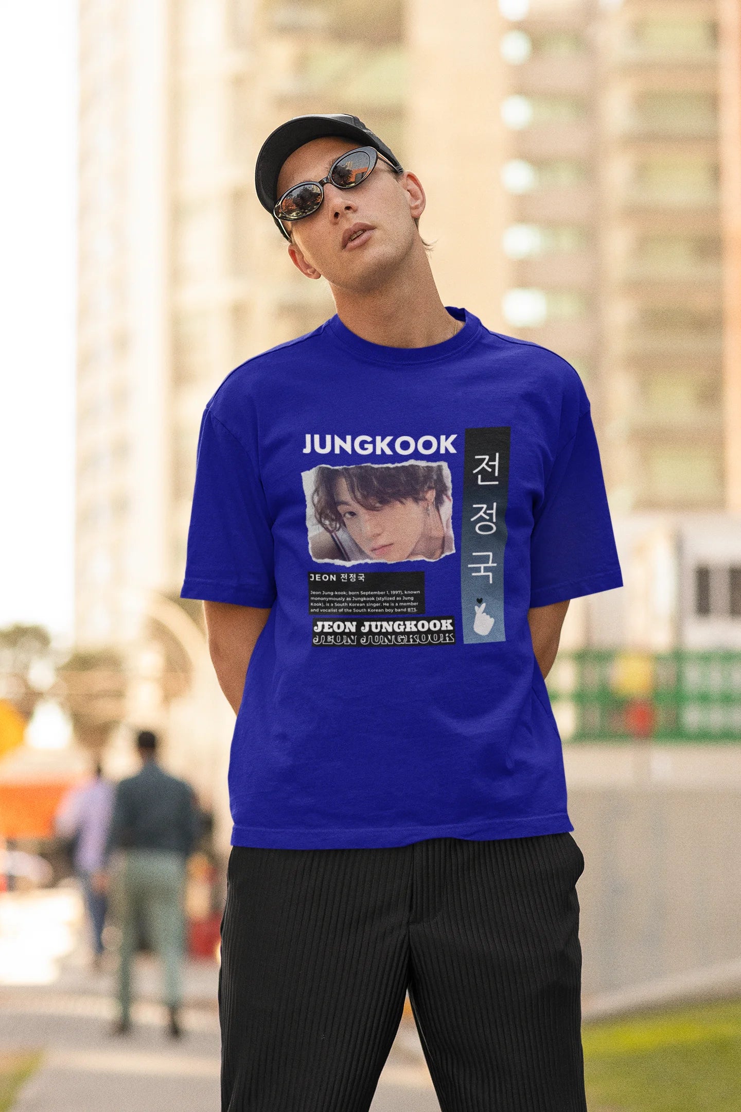Second front view of a male model wearing a royal blue oversized t-shirt featuring a vibrant design inspired by BTS member Jungkook. Ideal for fans of BTS and K-Pop music in general.