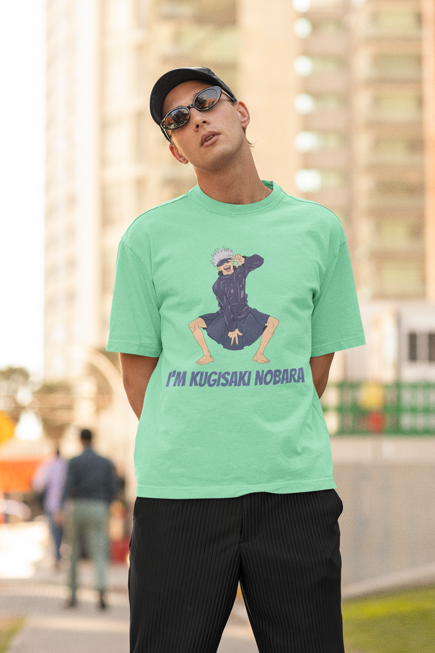 2nd front view of a male model wearing an mint green oversized t-shirt featuring Satoru Gojo dressed as Nobara Kugisaki.