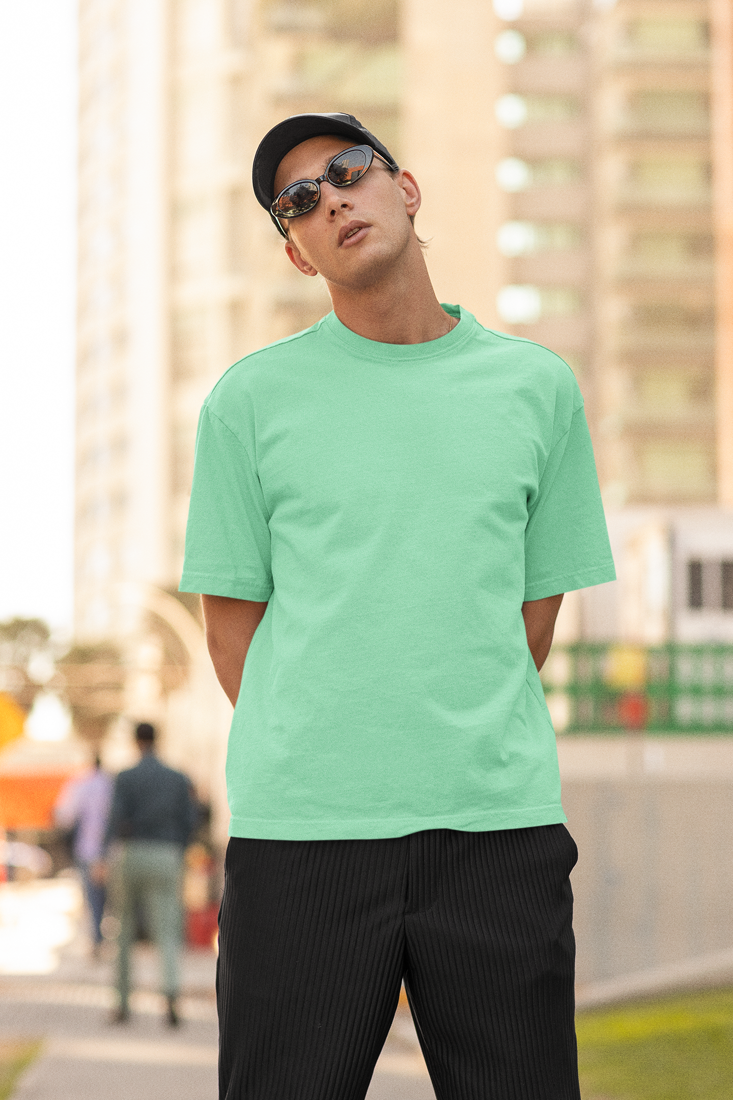 2nd front view of a male model wearing a mint green oversized t-shirt featuring Crocodile, the Desiccation Master, from the One Piece anime.