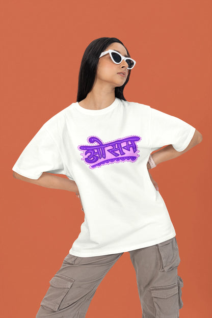 2nd front view of a female model wearing a off-white colored oversized graphic t-shirt featuring the word "awesome" in a Hindi script.
