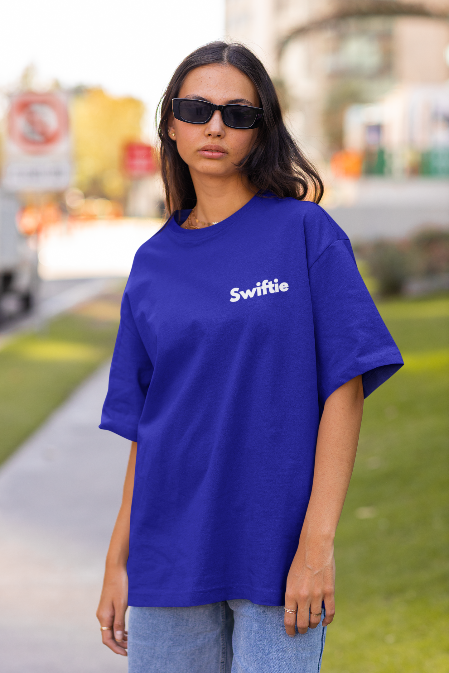 Front view of woman wearing blue Oversize T-shirt featuring Swiftie design, taylor's version