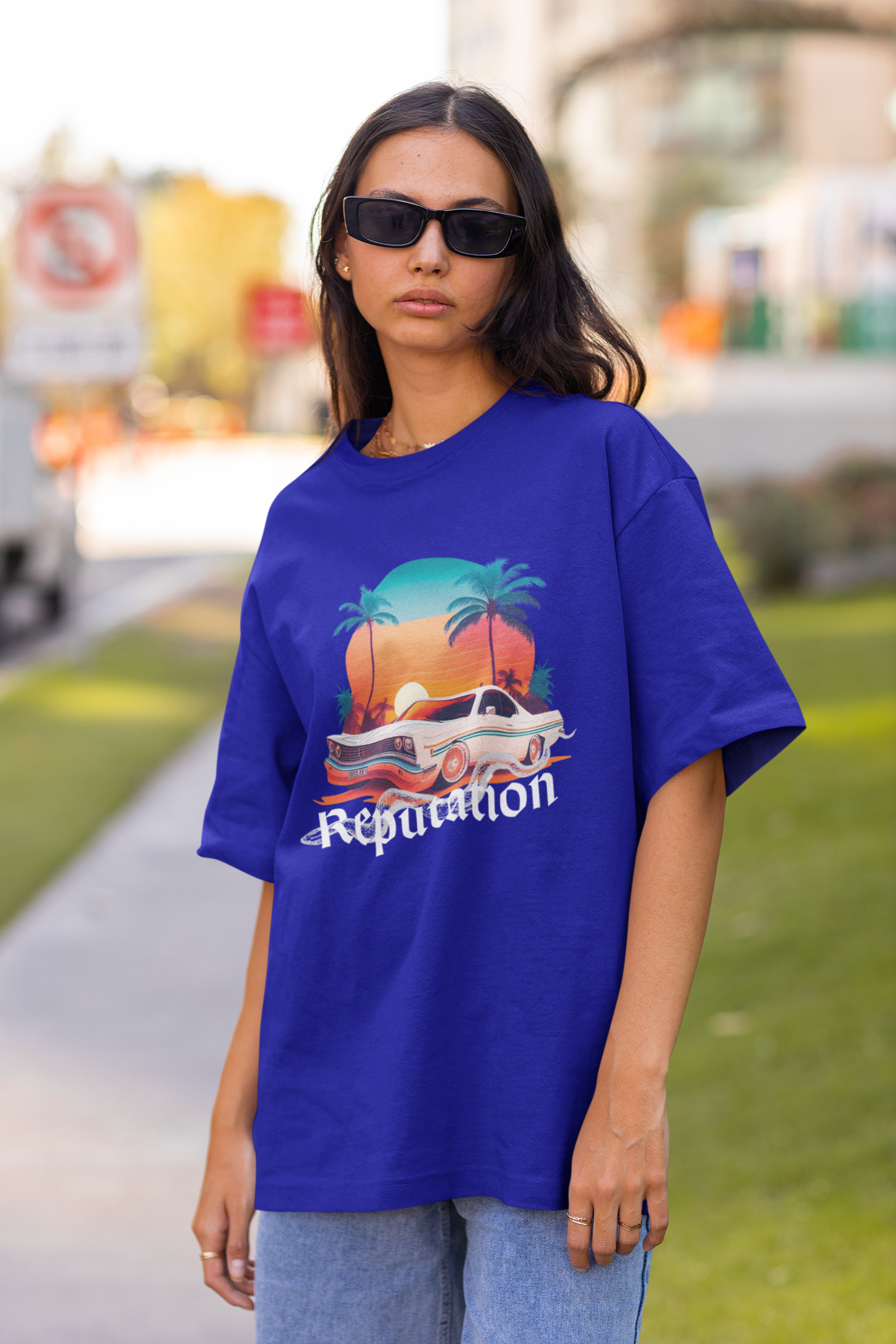 Front view of woman wearing blue Oversize t-shirt featuring Reputation Taylor's Version design inspired by Taylor Swift's Reputation era