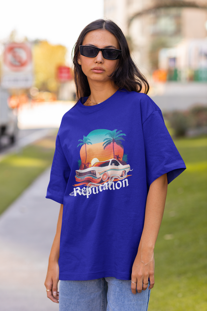 Front view of woman wearing blue Oversize t-shirt featuring Reputation Taylor's Version design inspired by Taylor Swift's Reputation era
