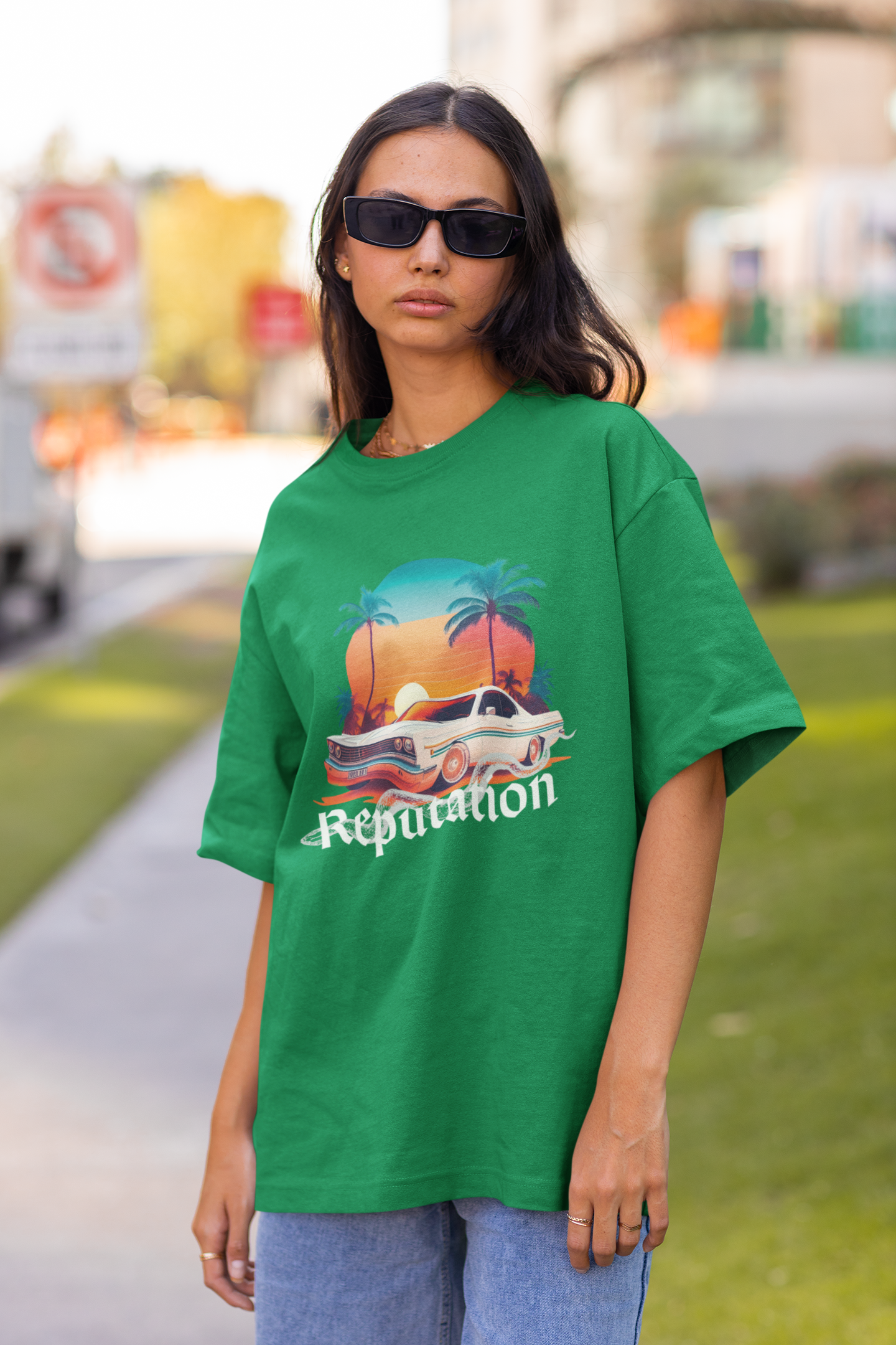 Front view of woman wearing green Oversize t-shirt featuring Reputation Taylor's Version design inspired by Taylor Swift's Reputation era