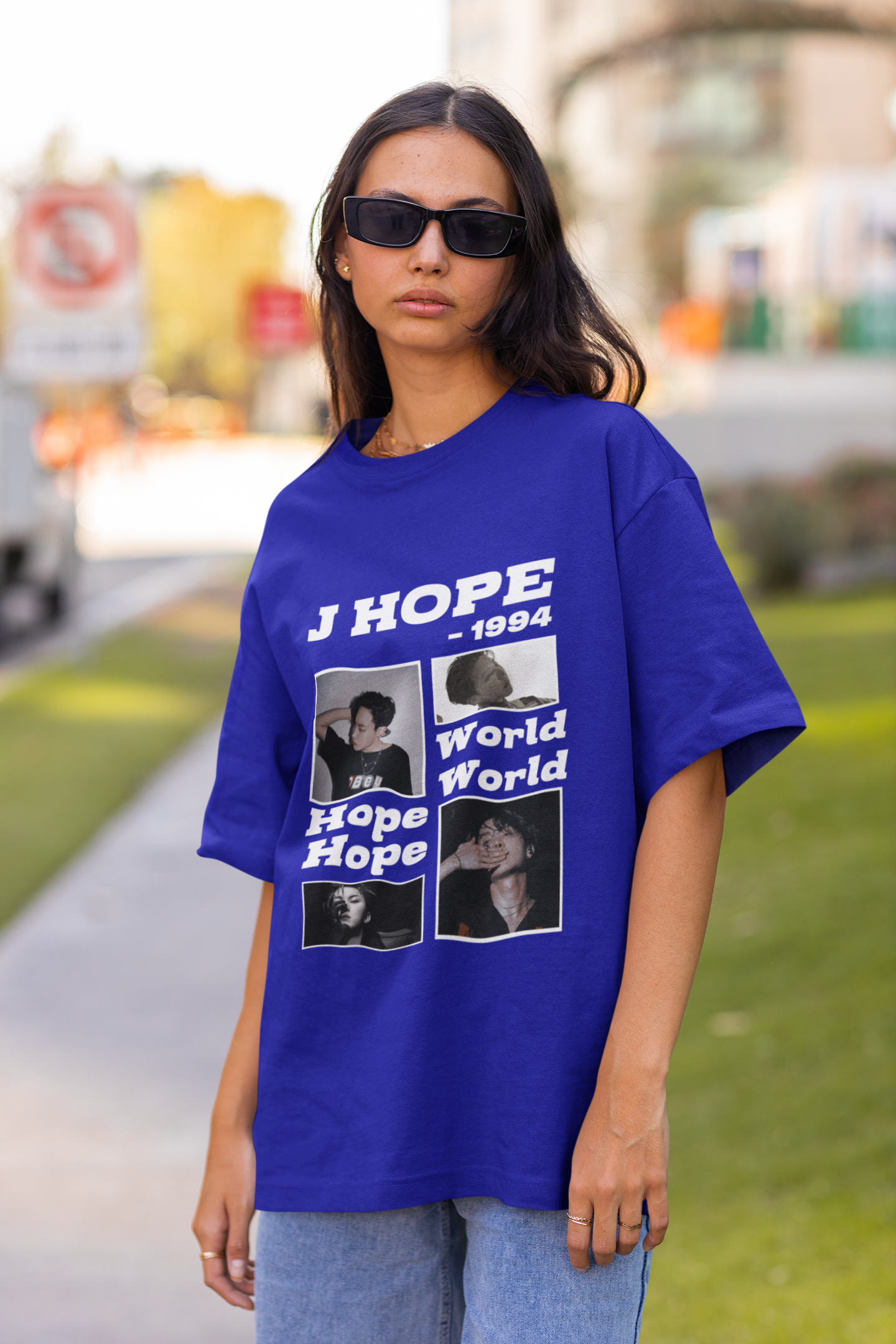 Front view of a female model wearing a royal blue oversized t-shirt featuring a vibrant design inspired by BTS member J-Hope (Hoseok). Ideal for BTS fans (ARMY) and K-Pop enthusiasts who love dance and rap-focused music.