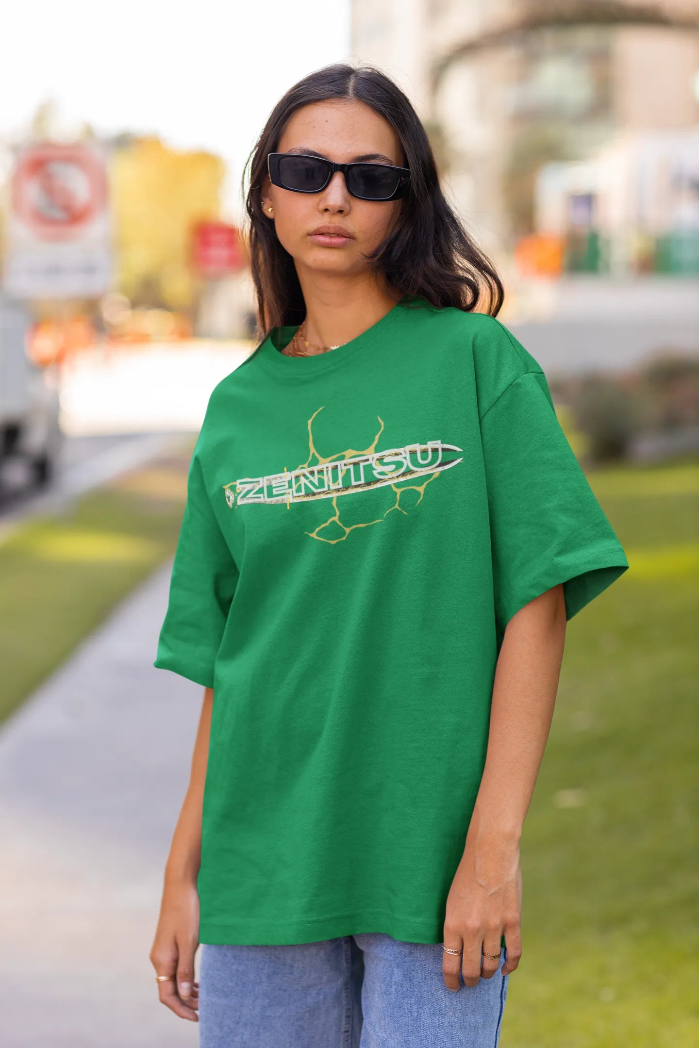 First front view of a female model wearing a forest green oversized t-shirt featuring Zenitsu Agatsuma with the text "High Voltage".