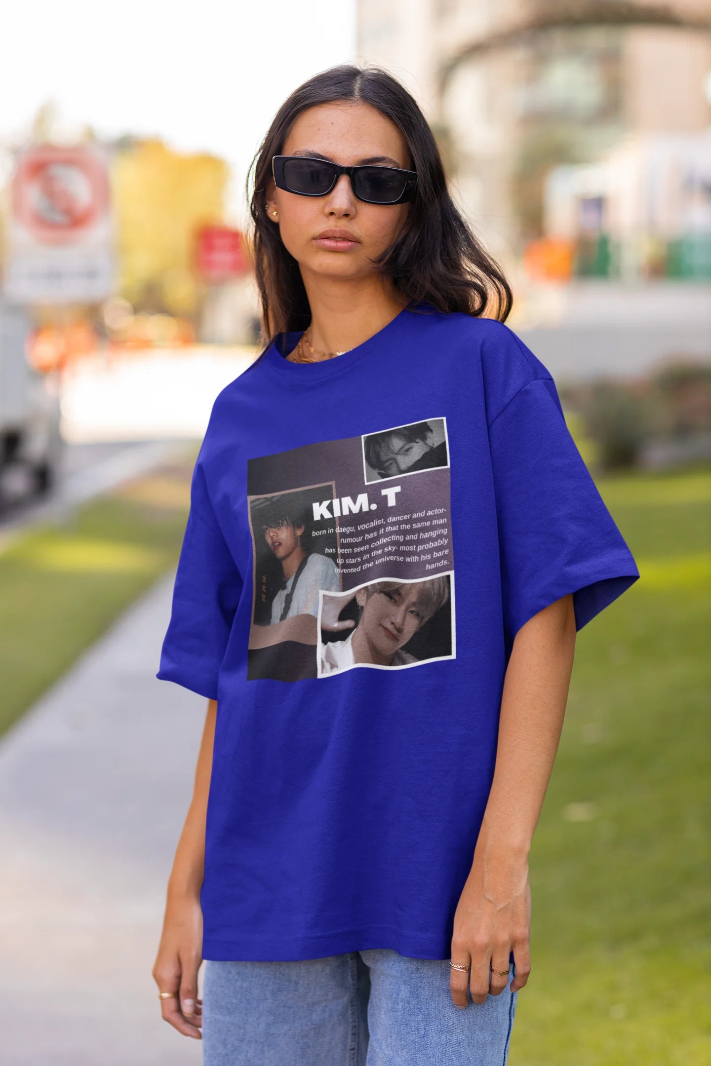 Front view of female model wearing a royal blue oversized t-shirt featuring a bold design inspired by BTS member Kim Taehyung (V). Ideal for BTS fans (ARMY) and K-Pop enthusiasts.