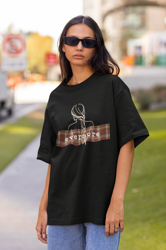 Front view of female model showcasing black oversized Taylor Swift Evermore design T-shirt from the Taylors Version Swiftie merch collection