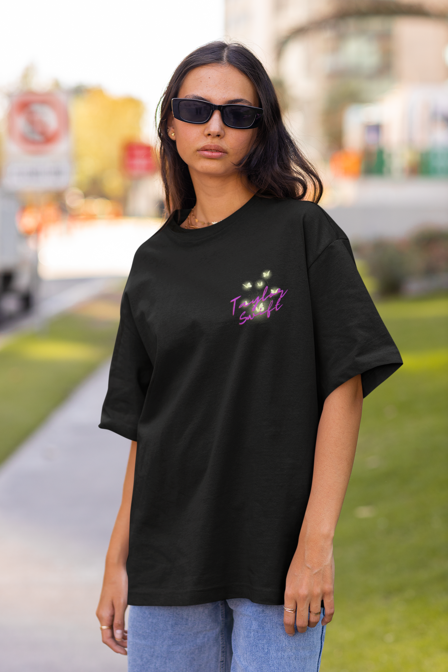 Front view of model wearing blue oversized Taylor Swift Willow t-shirt featuring designs inspired by her album Evermore (Taylor's Version)