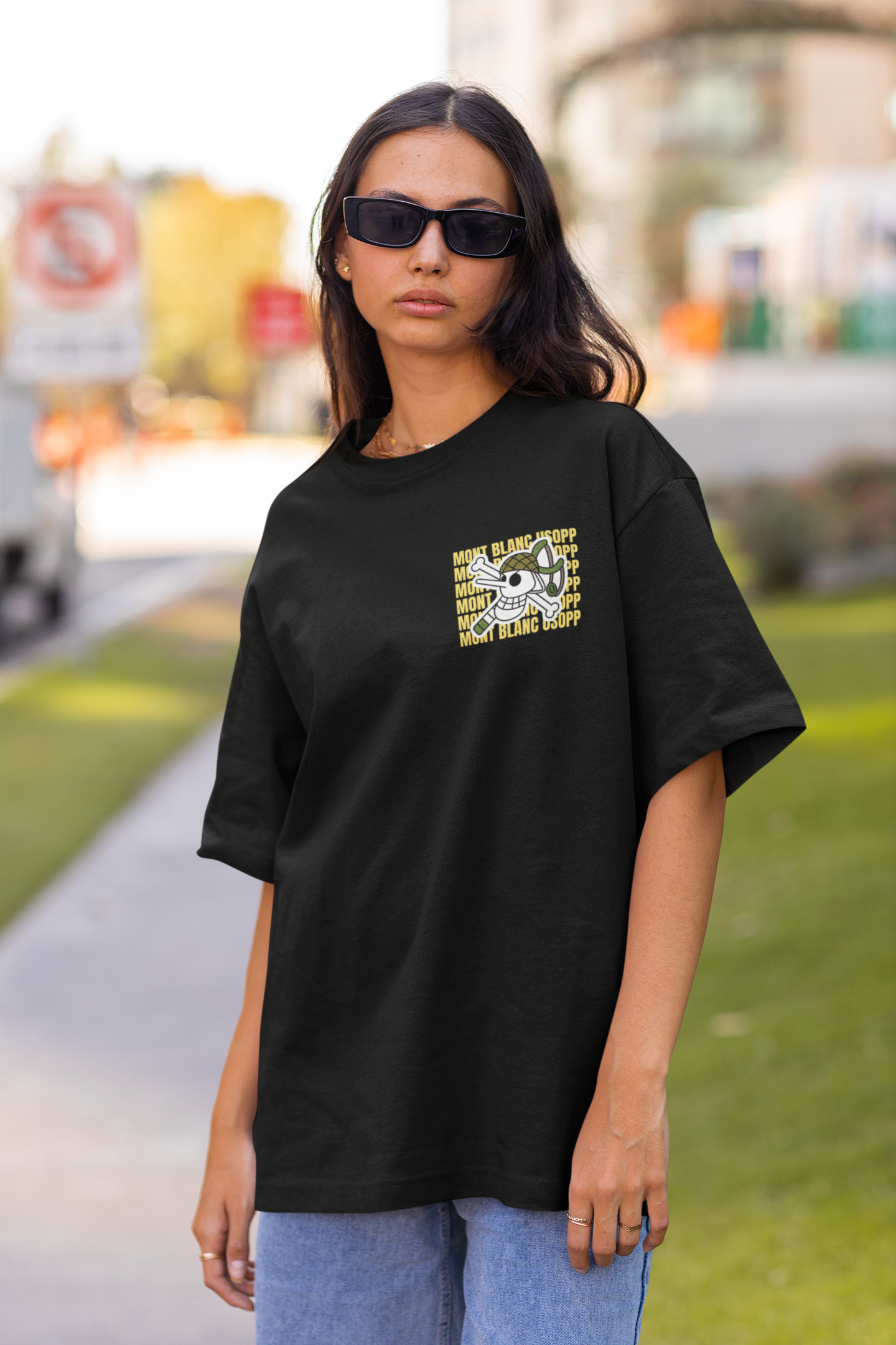 First front view of a female model wearing a black oversized t-shirt featuring Usopp from the One Piece anime.