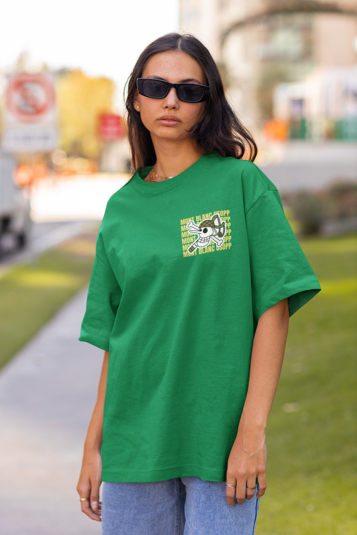 3rd front view of a female model wearing a forest green oversized t-shirt featuring Usopp from the One Piece anime.