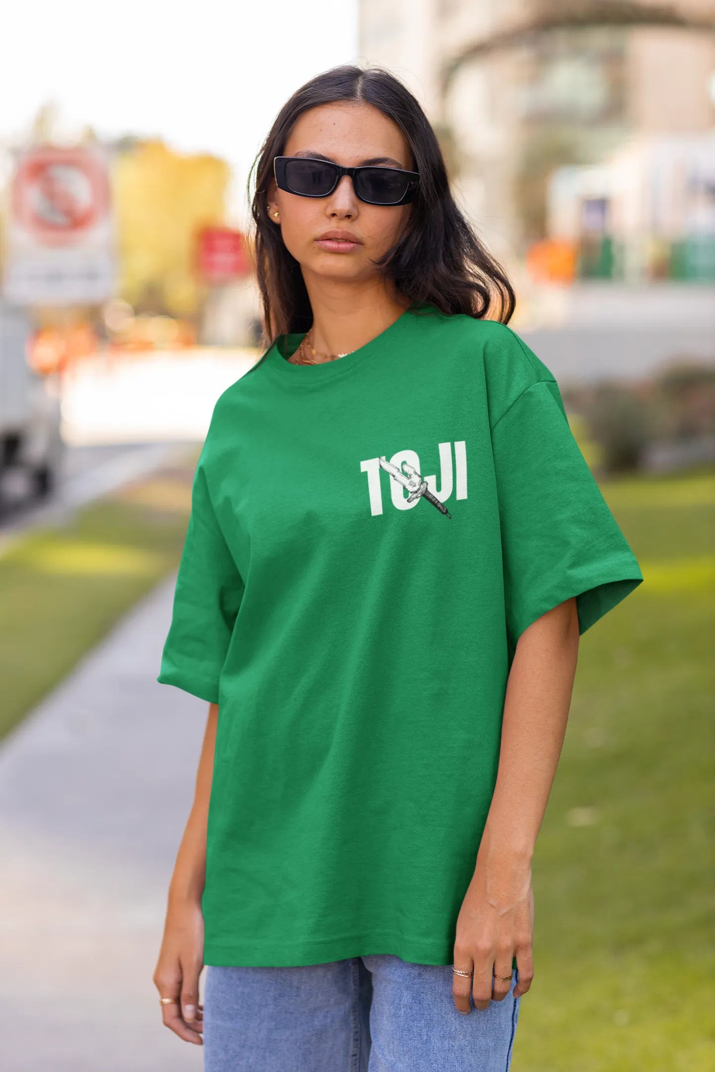 First front view of a female model wearing a forest green oversized t-shirt featuring Toji Fushiguro from the Jujutsu Kaisen anime.