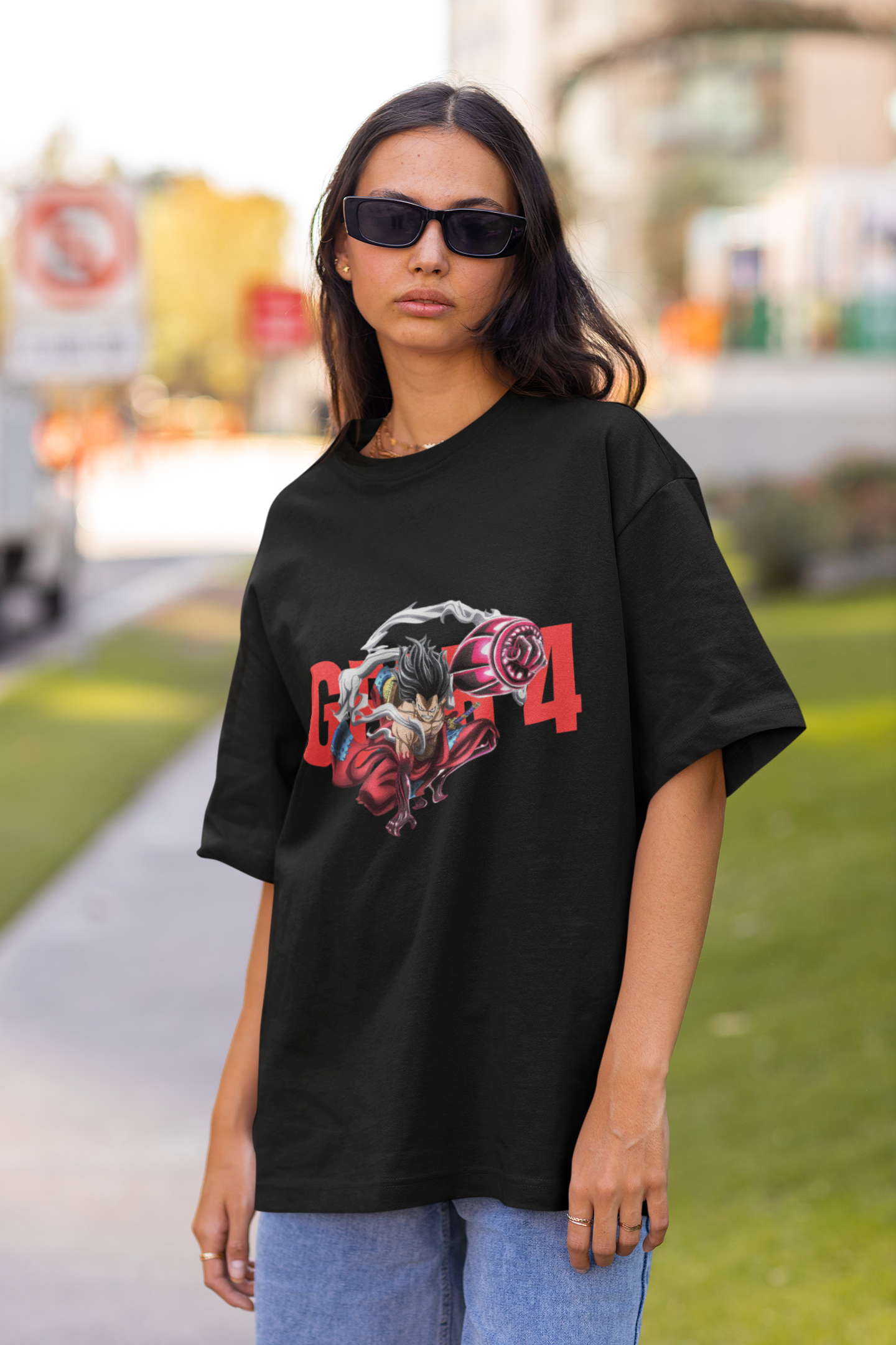 3rd front view of a female model wearing a black oversized t-shirt featuring Luffy in his Gear 4 Bounceman form from the One Piece anime.