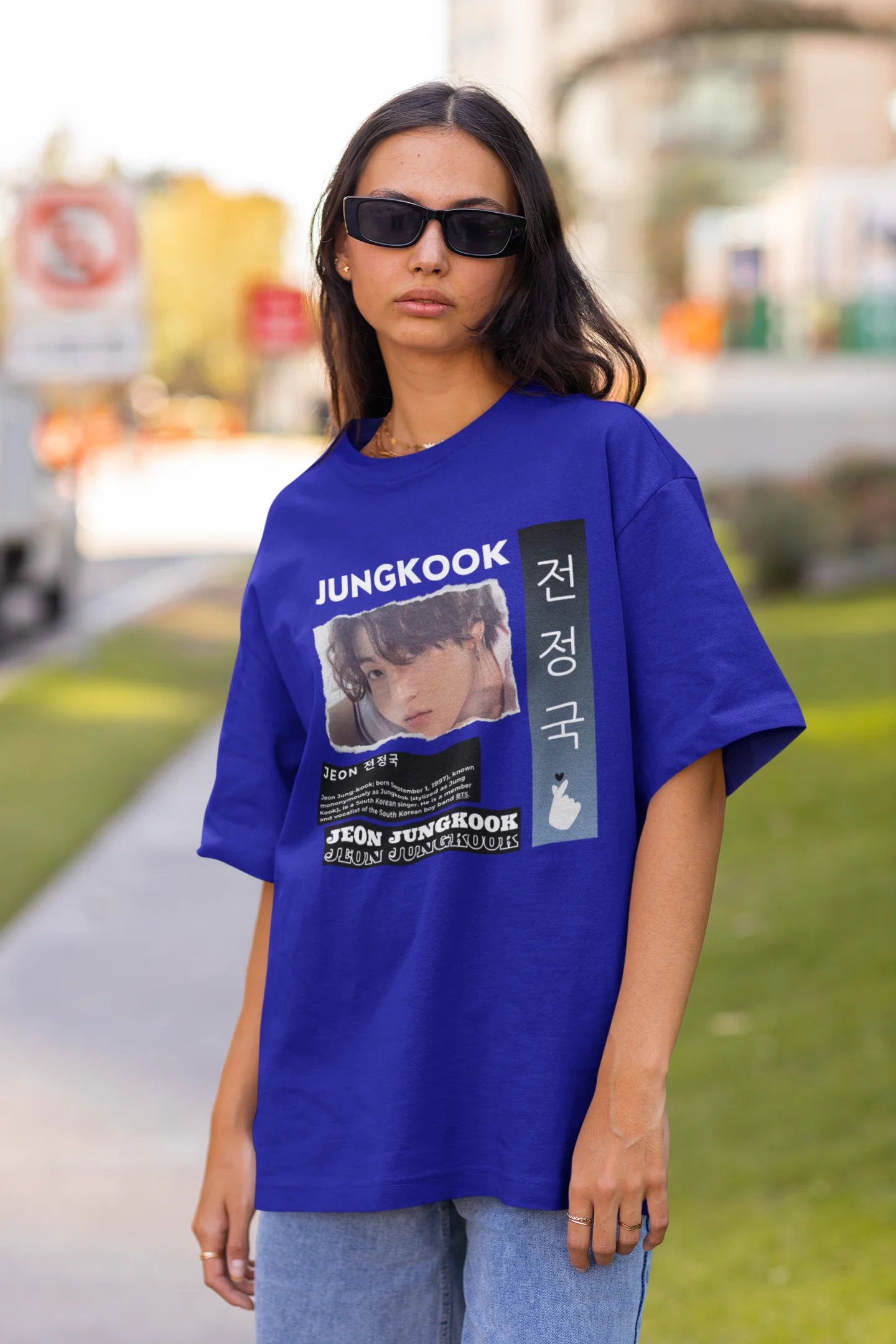 Front view of a female model wearing a royal blue oversized t-shirt featuring a vibrant design inspired by BTS member Jungkook. Ideal for fans of BTS and K-Pop music in general.