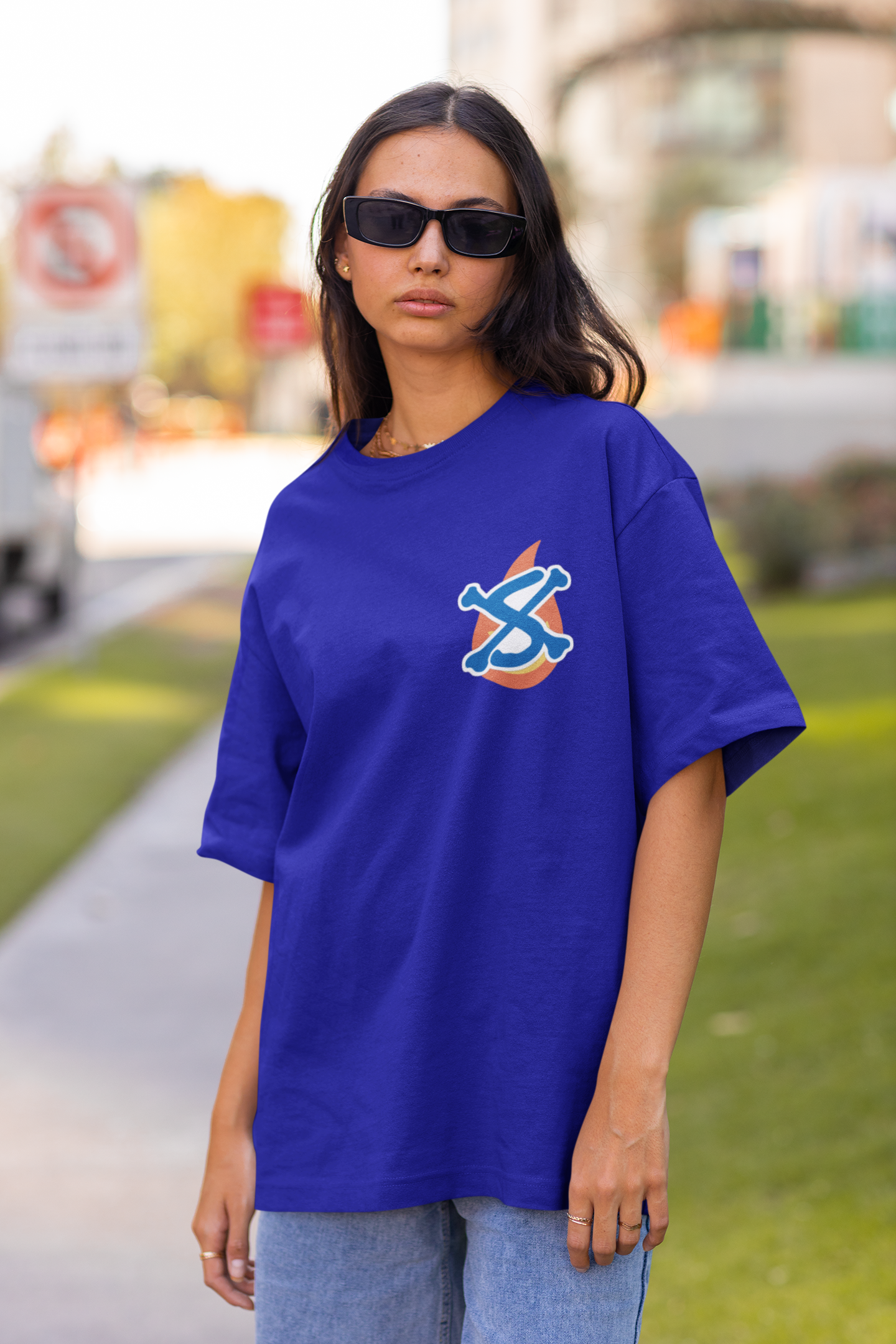 2nd front view of a female model wearing a royal blue oversized t-shirt featuring Sabo with the text "Flame Emperor."