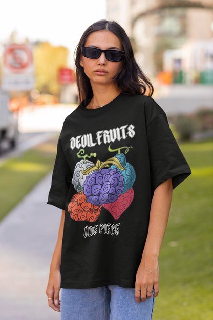 2nd front view of a female model wearing a black oversized t-shirt featuring a design of a Devil Fruit from the One Piece anime.