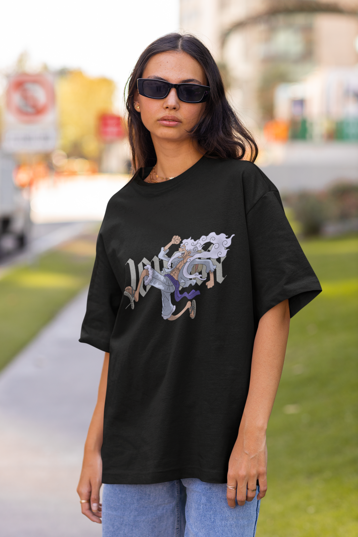 3rd front view of a female model wearing a black oversized t-shirt featuring Luffy in his Gear 5 form from the One Piece anime.