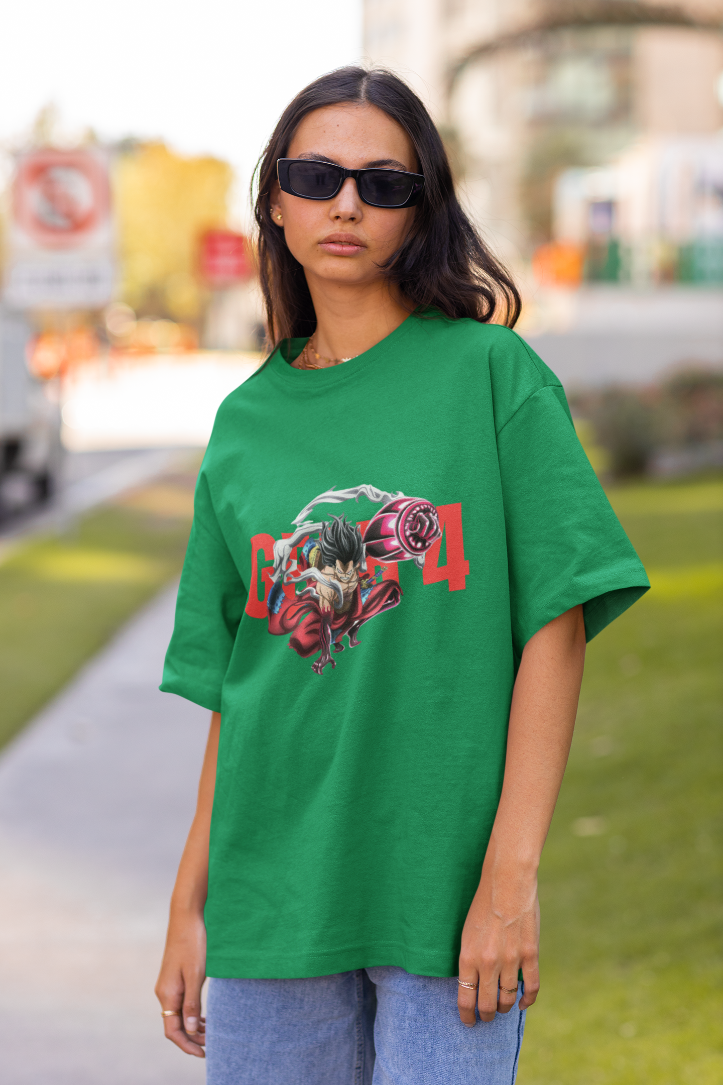 3rd front view of a female model wearing a forest green oversized t-shirt featuring Luffy in his Gear 4 Bounceman form from the One Piece anime.