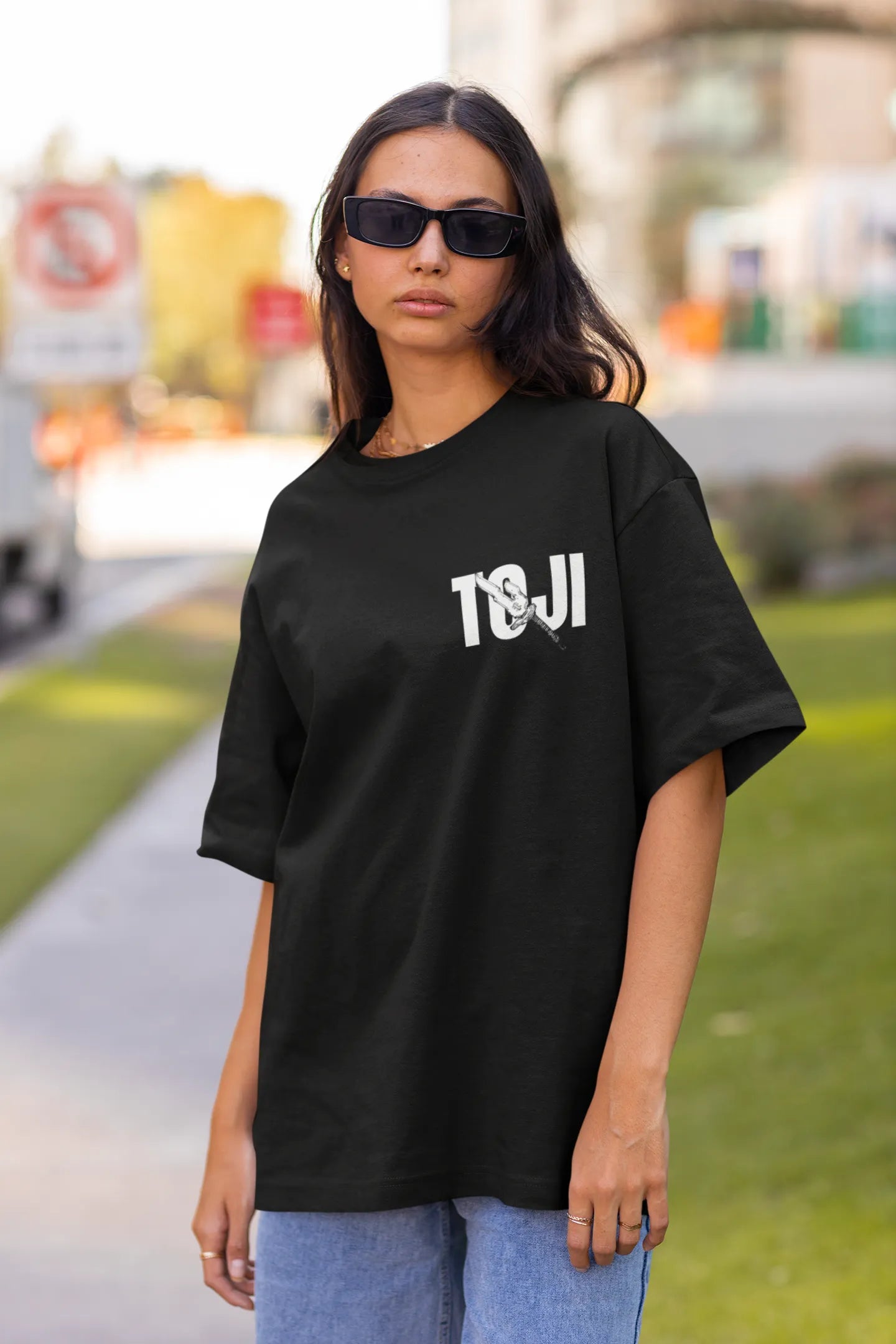 First front view of a female model wearing a black oversized t-shirt featuring Toji Fushiguro from the Jujutsu Kaisen anime.