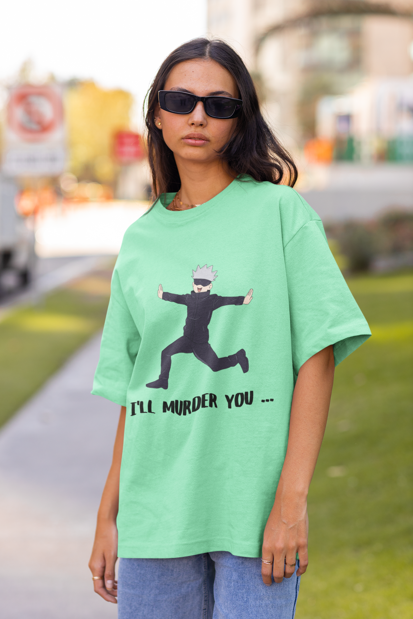 2nd front view of a female model wearing a mint green oversized t-shirt featuring Gojo Satoru in a silly pose with the text "I Will Murder You."