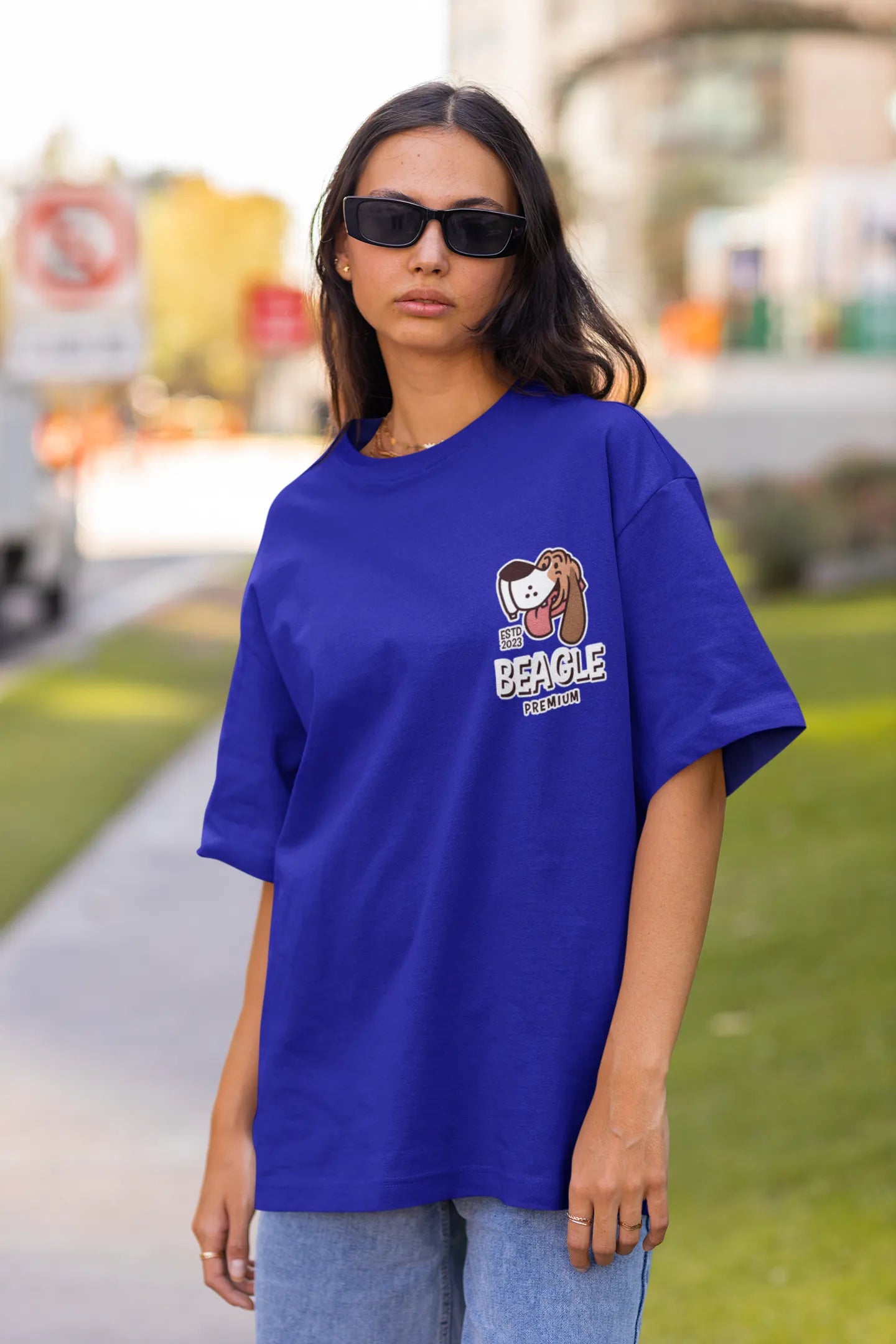 Front view of female Model showcasing blue oversized tee with a The Beagles animated series themed design, featuring the cool canine quartet from ourt disney collection of oversized tees.