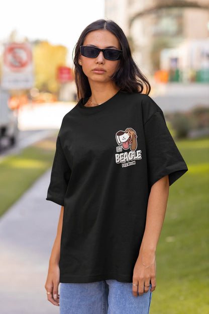 Front view of female Model showcasing black oversized tee with a The Beagles animated series themed design, featuring the cool canine quartet from ourt disney collection of oversized tees.
