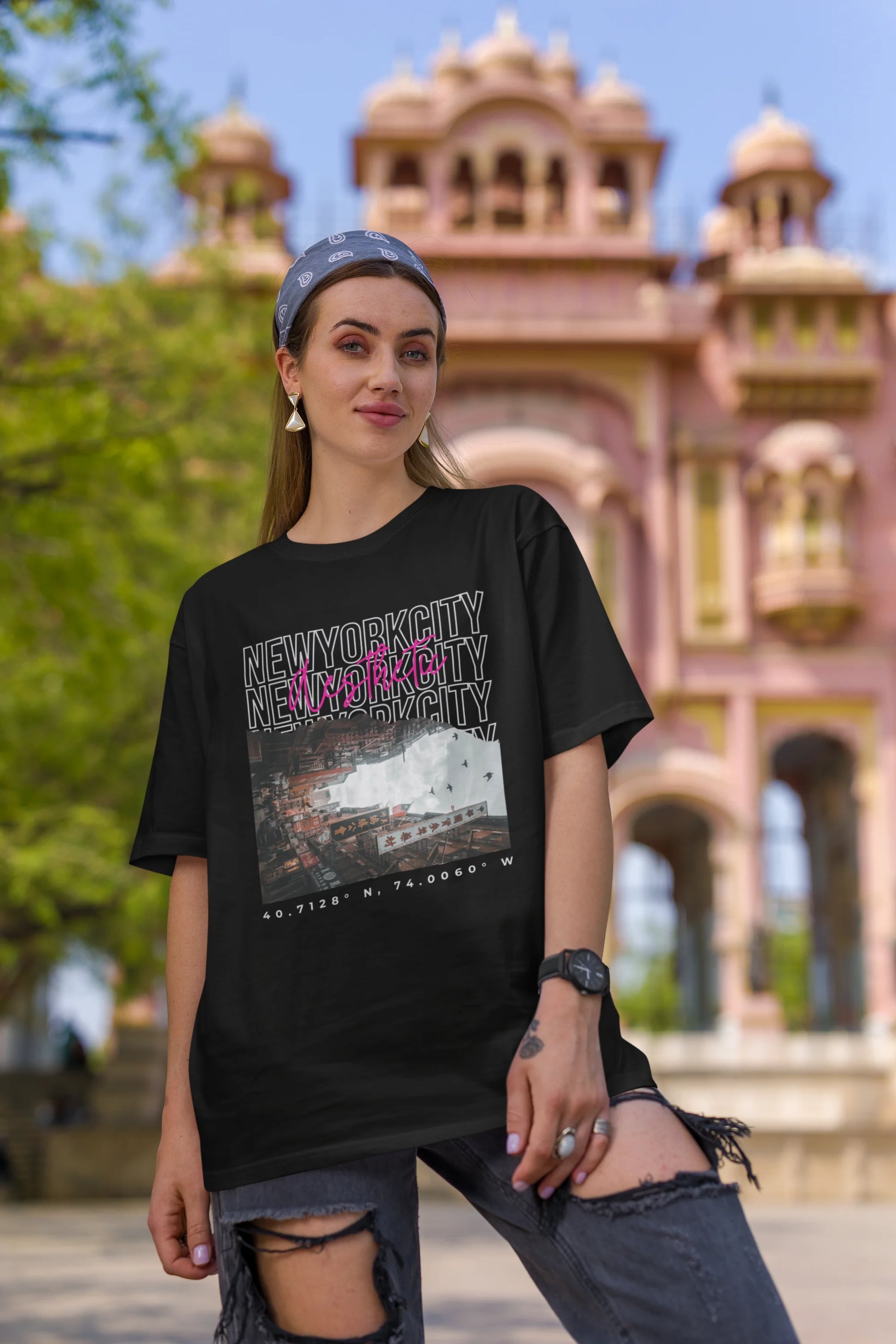 First front view of a female model wearing an black oversized t-shirt with a New York City skyline design, offering a relaxed urban aesthetic.