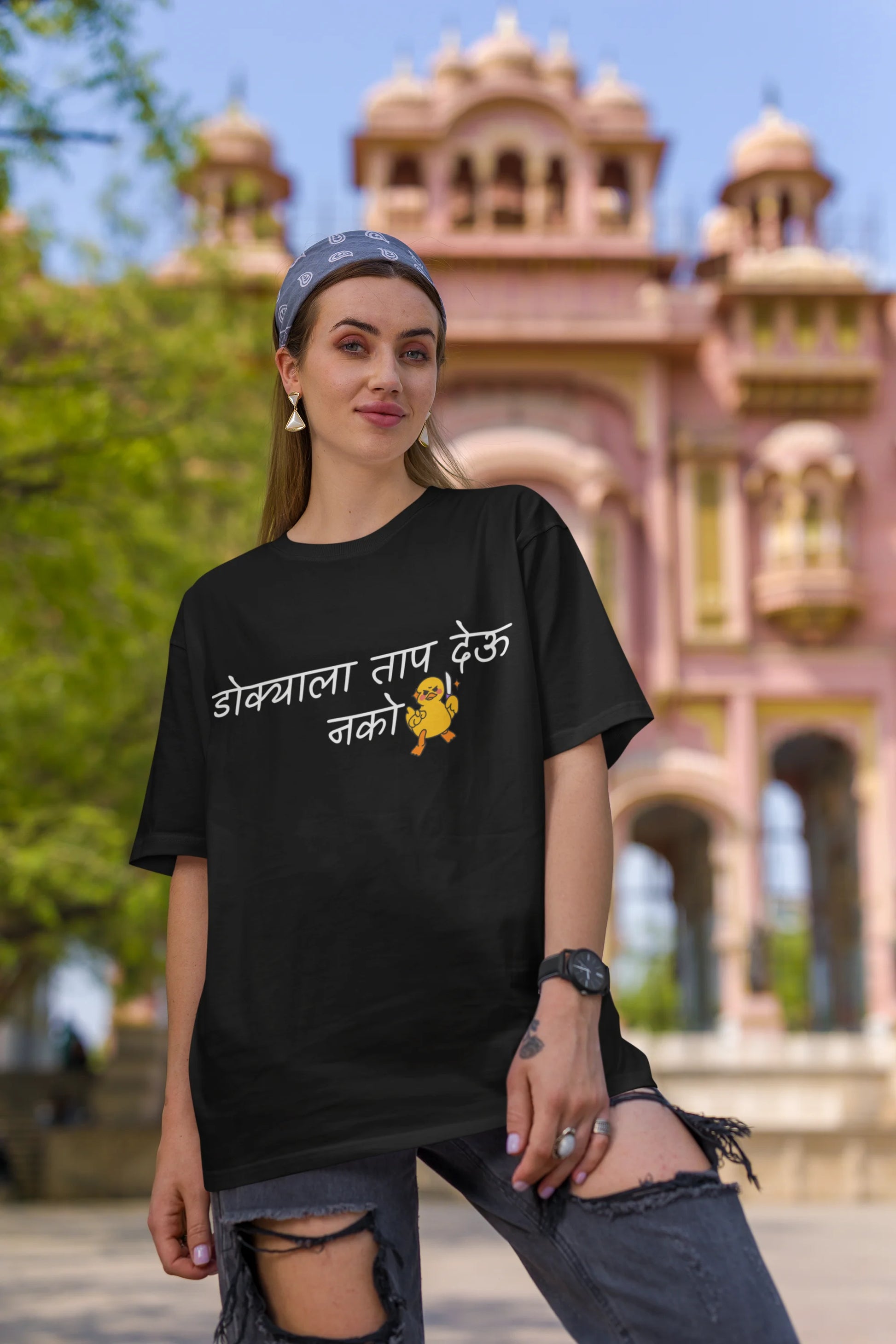 First front view of a female model wearing a black oversized t-shirt featuring a design inspired by Marathi culture. Perfect for anyone who loves Maharashtra and its vibrant traditions.