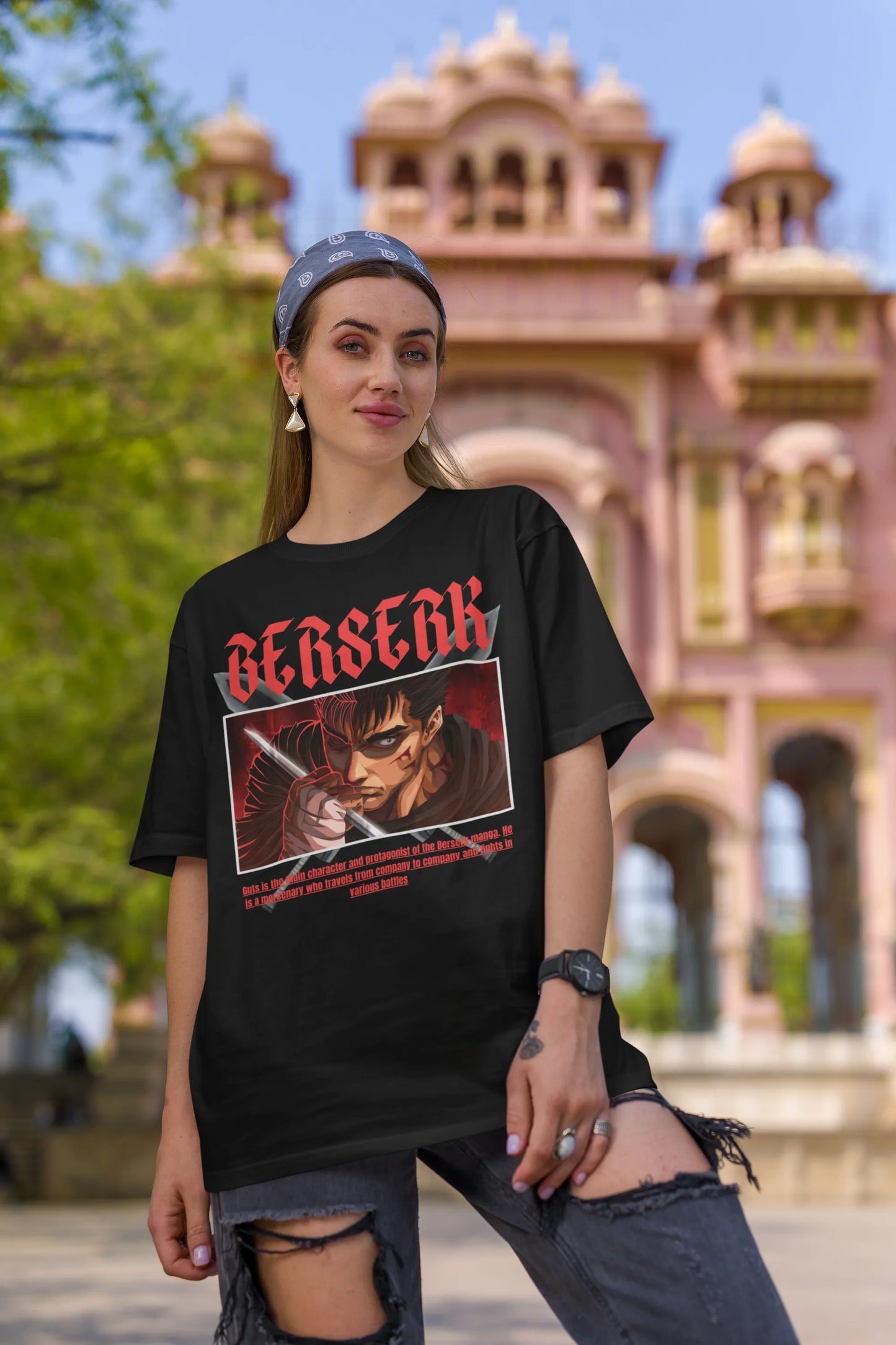 2nd front view of a female model wearing an black oversized t-shirt featuring Guts from the Berserk anime with the text "Berserk" across the design.