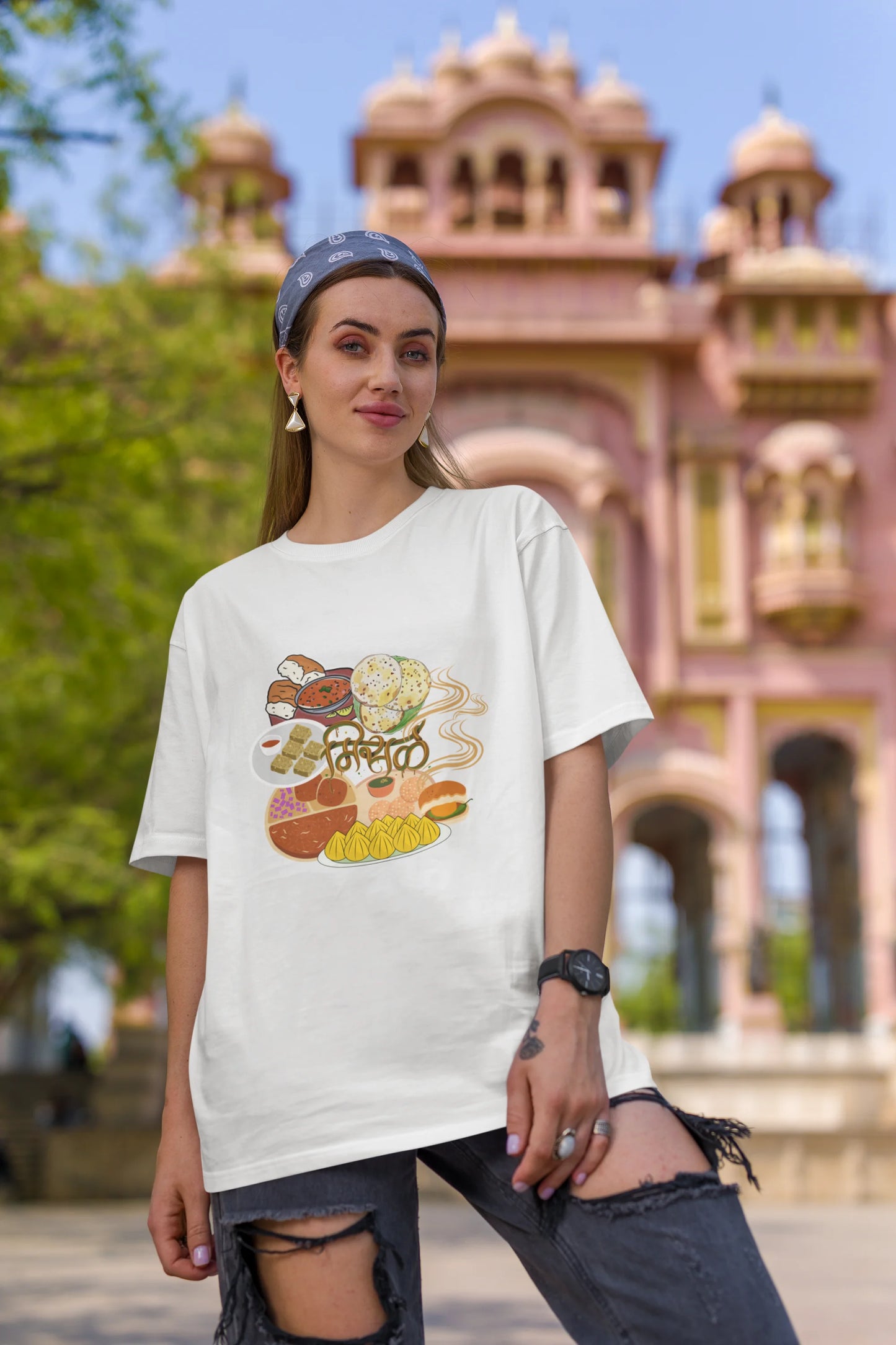 First front view of female model wearing an off white oversized t-shirt featuring a design inspired by the Marathi dish Misal Pav. Ideal for fans of Marathi culture, foodies, and anyone who loves a flavorful meal.