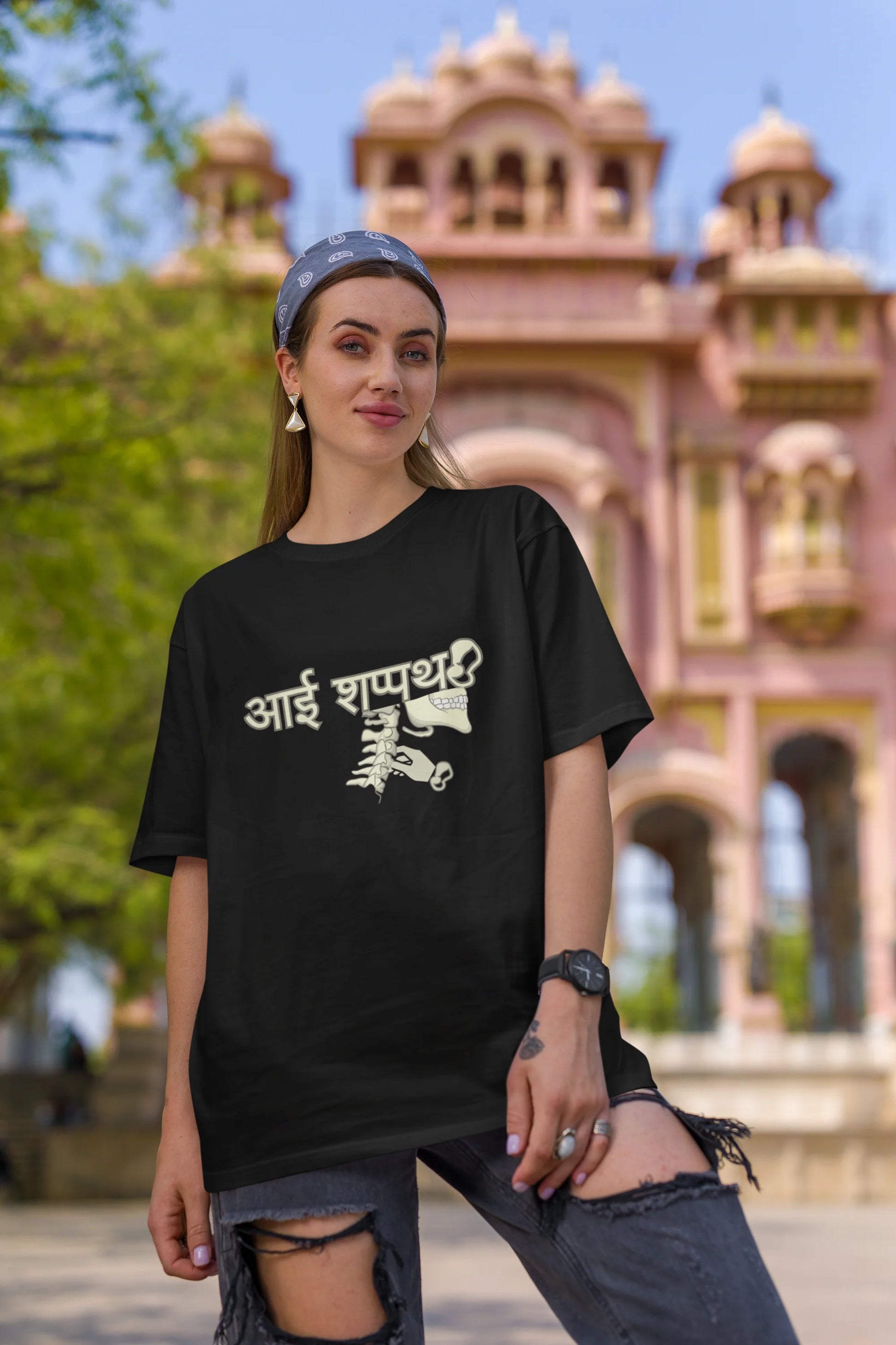 Second front view of female model wearing a black oversized t-shirt featuring a design inspired by the Marathi saying "Aai Sapath." Perfect for fans of Marathi culture and anyone who wants to celebrate their heritage.