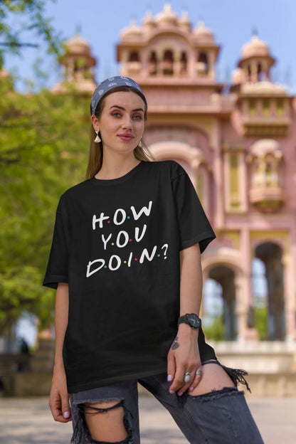 First image of female model wearing black oversized t-shirt with F.R.I.E.N.D.S series inspired designs, embodying Joey's famous catchphrase 'How You Doin'?