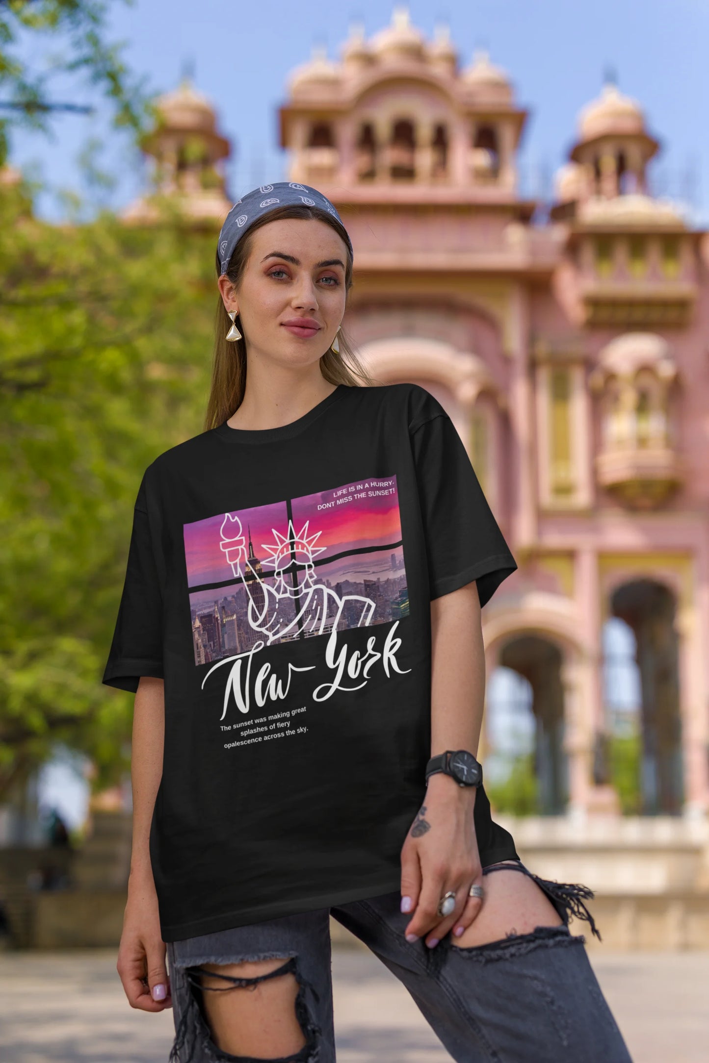 First front view of a female model wearing a black oversized t-shirt with a New York City skyline design, offering a relaxed urban aesthetic.
