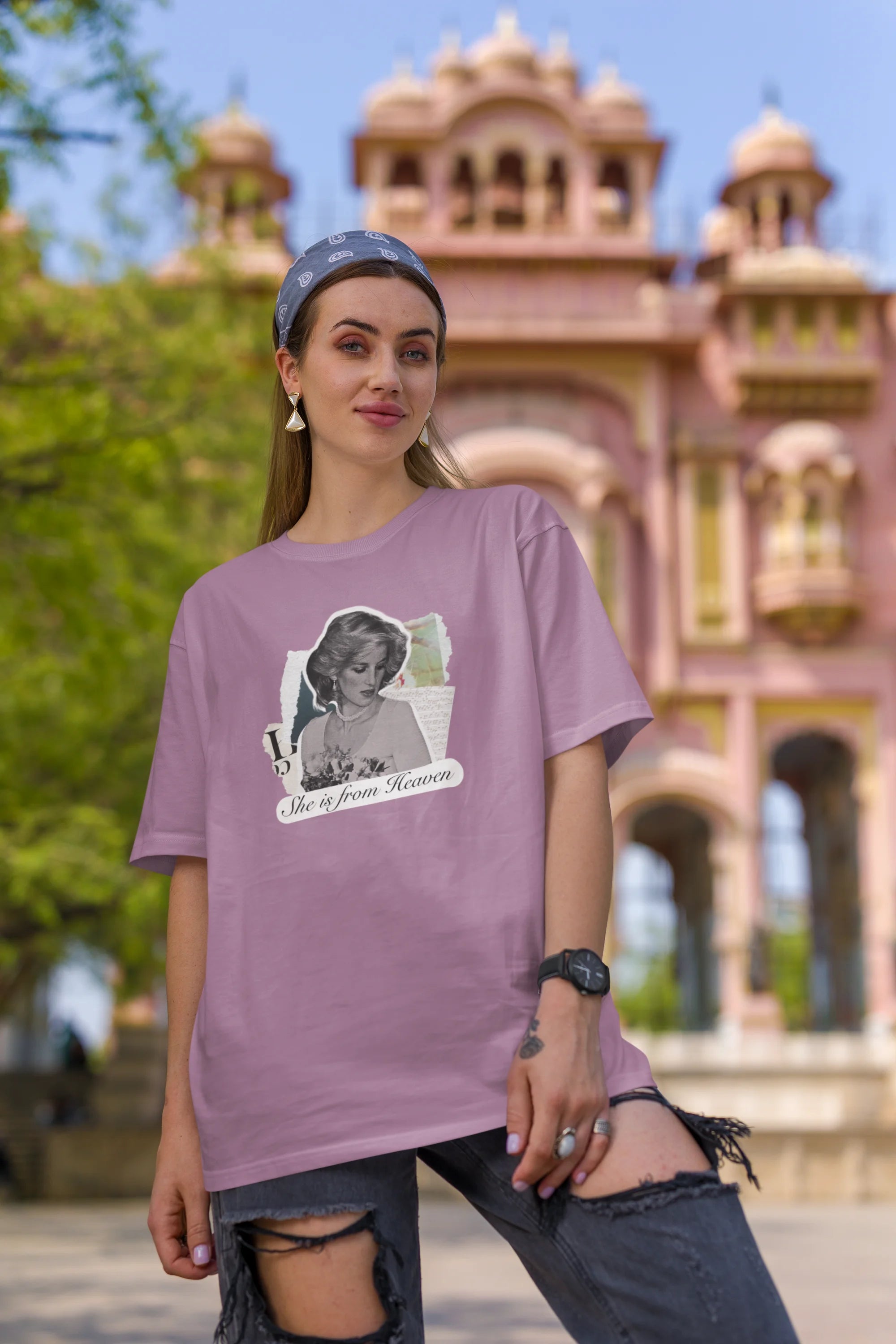 First front view of female model wearing a dirty purple oversized t-shirt featuring a black and white photo of Princess Diana with the text "She is from Heaven." Ideal for fans of Princess Diana and those who want to celebrate a royal icon.