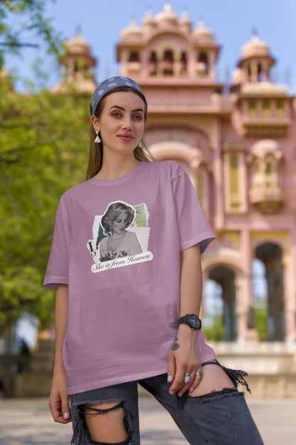 First front view of female model wearing a dirty purple oversized t-shirt featuring a black and white photo of Princess Diana with the text "She is from Heaven." Ideal for fans of Princess Diana and those who want to celebrate a royal icon.