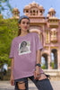 First front view of female model wearing a dirty purple oversized t-shirt featuring a black and white photo of Princess Diana with the text 