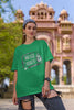 First image of woman wearing green coloured Oversized Taylor Swift T-Shirt featuring TTPD inspired design.