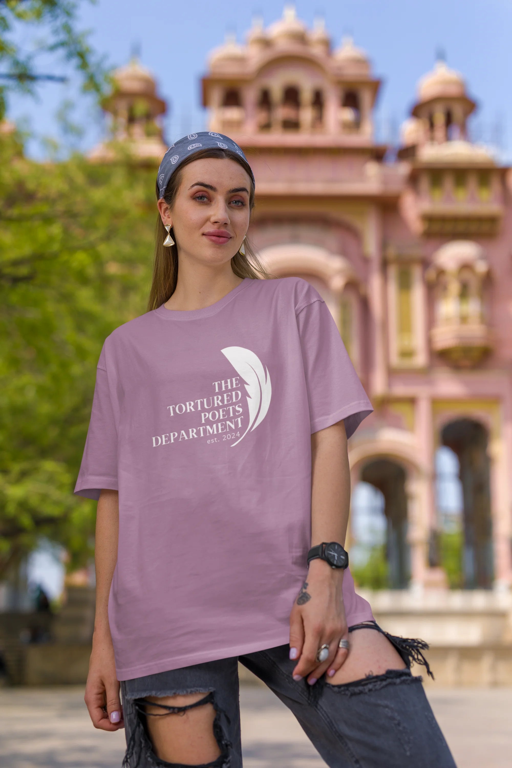 Second image of woman wearing dirty purple coloured Oversized Taylor Swift T-Shirt featuring TTPD design.