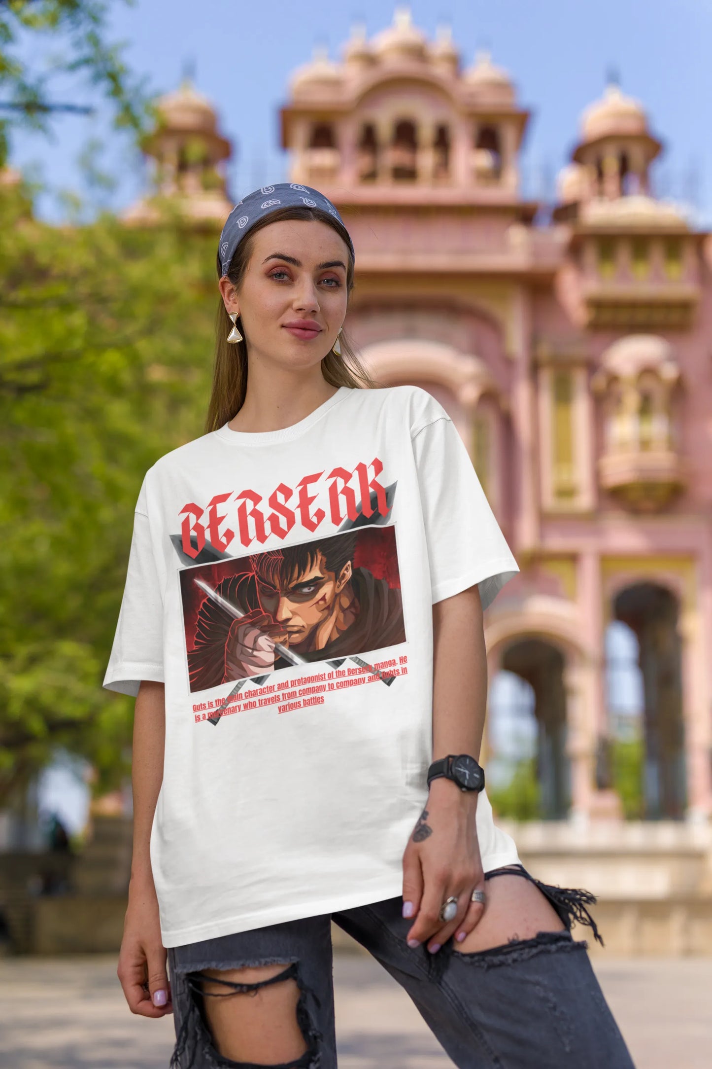 First front view of a female model wearing an off-white oversized t-shirt featuring Guts from the Berserk anime with the text "Berserk" across the design.