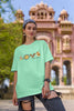 First front view of a female model wearing an mint green oversized t-shirt with a colorful design that celebrates Marathi culture. Ideal for anyone who loves Maharashtra and its vibrant heritage.