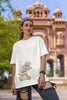 First image of female model wearing off-white oversized tee with a Disney's Chip and Dale design, featuring the adorable duo in a playful scene.