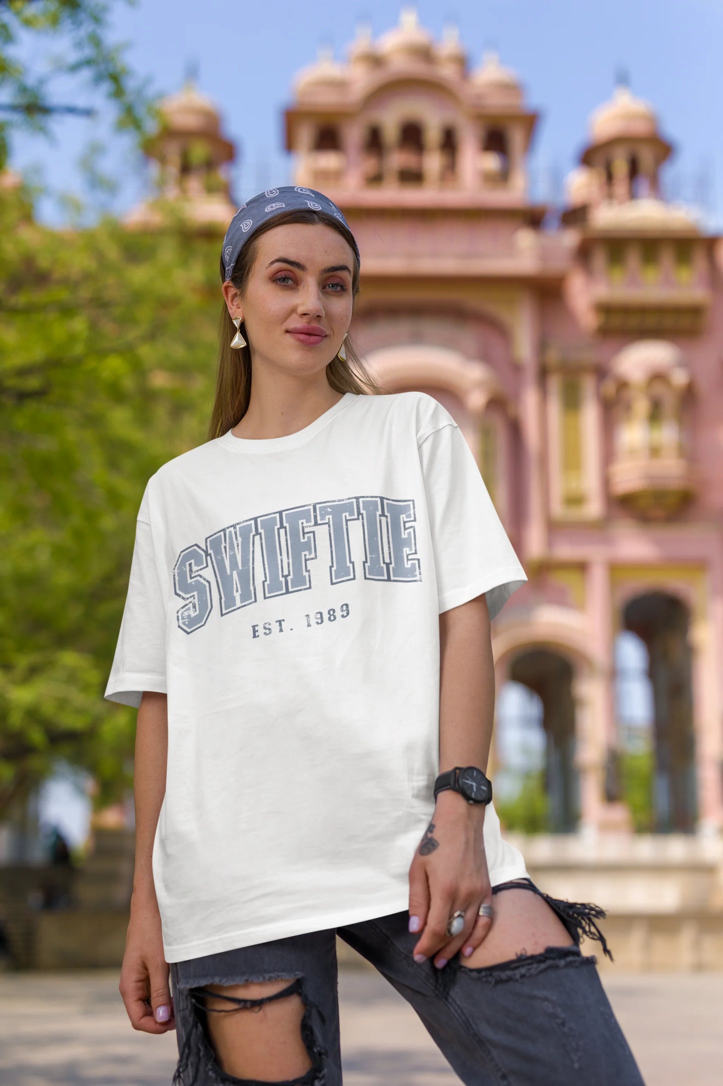 First image of woman wearing off white Oversize T-shirt featuring Swiftie design, taylor's version