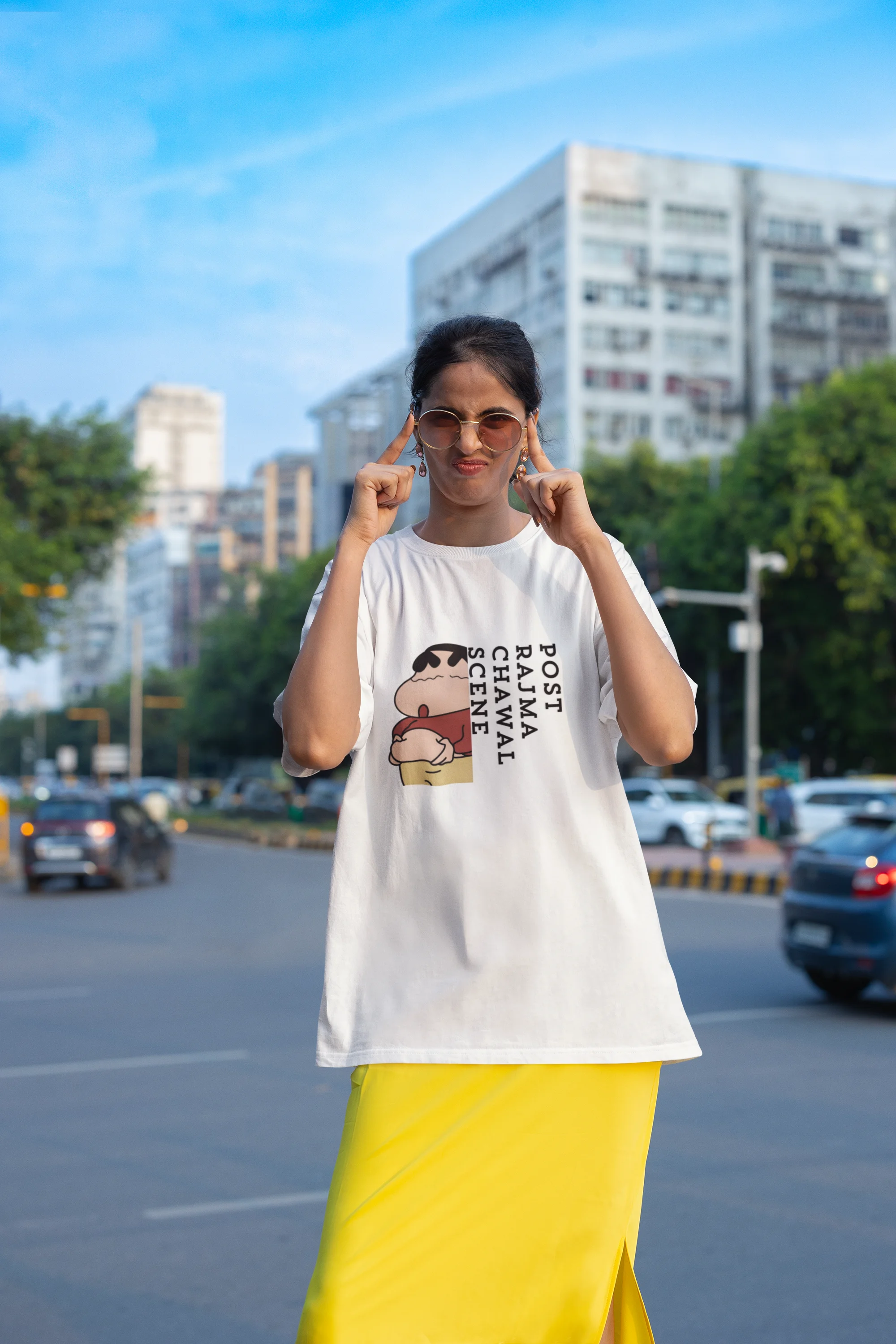 Fourth front image of female model wearing an oversized off-white tee with a humorous design of Shinchan enjoying a food coma. A must-have for Shinchan fans and food lovers.